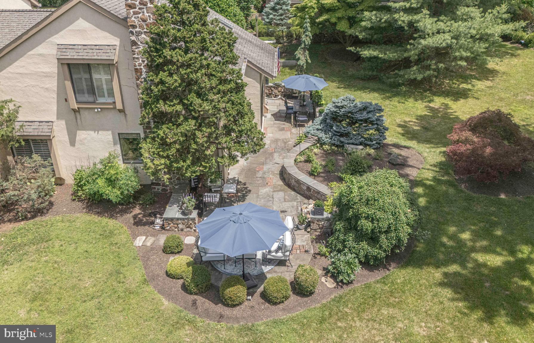 Spectacular 4 bedroom, 3.5 bath  end-unit townhome in prestigious Sugar Knoll is nestled in the heart of the  Main Line, yet offers the privacy of a lush  18  acre estate shared by just 32 carriage homes.  Built by  prominent Hank Belber, this rare treasure features superior craftsmanship, blending innovative design with high-end finishes and architectural millwork. Just minutes from all the epicurean restaurants and indulgent shopping of vibrant downtown Wayne , as well as the Devon Horse Show, Jenkins Arboretum, Valley Forge National Park, Aronimink Golf Club, St Davids Country & Radnor Valley Country Clubs,  Historic Waynesborough, and Wilson Farm Park.  Step into the bright foyer with sidelights , new European white oak 9 inch  flooring, and soaring windows. The  sundrenched living room is complete with  gleaming Pinnacle Collection Crescendo engineered hardwood floors, dramatic brick fireplace with custom mantle & hand laid brick hearth, plantation blinds, recessed lighting, and crown molding.  The impressive kitchen is well-equipped for a culinary artist, complete with  luxury wide-plank flooring, sleek white cabinets with several accent glass doors, premium Corian countertops , glazed subway tile backsplash, soft-close dove-tail drawers, stainless steel appliances & hood, double sink, new LG dishwasher with interior lighting, oversized island with mesmerizing raw granite , recessed lighting, and new sliders to an outdoor breakfast nook! The elegant dining room features aged European White Oak wide-plank floors, Perigold chandelier, built-in shelving, three-dimensional chair rail, crown molding, & recessed lighting! The library/ office is highlighted by the cozy wood-burning fireplace, new sliders, sophisticated millwork, and timeless built-ins  that add aesthetic interest while providing ample display space, accented with recessed lighting.  The magnificent primary suite  on the main level boasts new Pinnacle Collection engineered hardwood flooring, Pottery Barn sconces, plantation shutters, enormous walk-in closet with Serena & Lily wallpaper & crystal chandelier, second Closets by Design California closet, and a luxurious en-suite with expansive floor-to-ceiling tiled  shower with seat, marble sink with stainless steel fixtures,  plantation blinds, and a water closet. The 2nd floor primary suite is massive with wall-to-wall carpeting, a  huge closet with custom shelving,  and full bathroom with tiled tub/shower and a skylight. The additional lovely bedrooms  are spacious, with large closets, plush carpeting, and share a hall bathroom with shower.  The stunning outdoor space is highlighted by a wrap-around yard & terrace enveloping your entire home... feels like your very own botanical gardens, with professionally manicured grounds, delicate Japanese maple, vivid flowering shrubs,  awe-inspiring trees, captivating wildlife, 2 miniature ponds with water features, and textured flagstone, harmonizing natural aesthetics with a rustic, inviting appeal. Don't forget the oversized 1-car garage, recessed lighting with dimmer switches, Premium European White Oak 9 " wide plank flooring throughout first floor, four brand-new Anderson sliders,   dual-zoned HVAC,  and LG washer & dryer .  Award-winning Tredyffrin-Easton School District! Maintenance free with the HOA providing exterior building maintenance, snow & trash removal, all grounds & common area maintenance, and landscaping.