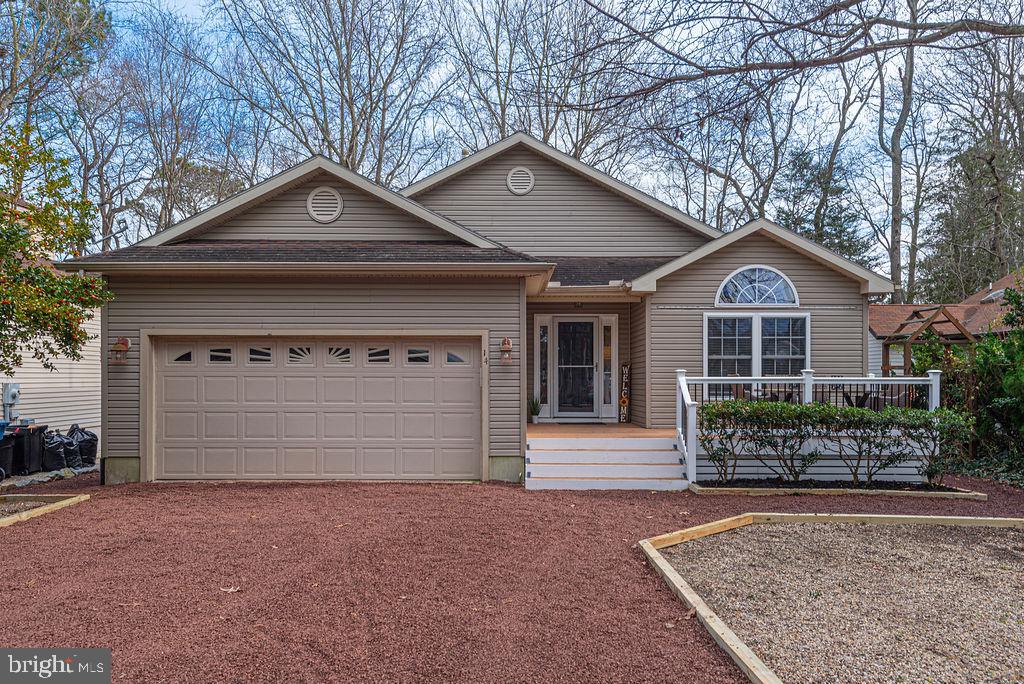 This home offers a great floorplan with convenient, one level living. Over 1,700 s.f. and comes complete with updated kitchen & baths and a 2 car garage! The kitchen has beautiful Quartz countertops,  stainless steel appliances (all less than 2 years old), gas range, soft close cabinetry and a pantry. Ambient lighting under cabinets and above adds to the cozy ambiance.  Both bathrooms feature beautiful custom ceramic tile showers, nice sized vanities and a window. The family room has vaulted ceilings and a gas fireplace. Capture scenic views of the golf course from the front deck, and indulge in relaxation on the screened porch, complete with a hot tub. There is also a ground level patio. Ample storage is found throughout, including a pantry, coat closet, linen closet, walk-in closet, and an attic. Nestled in the charming Ocean Pines community, this residence offers more than just a home—it offers outstanding amenities such as pools, golf course, racquet center, and parks. Situated within walking distance to the community clubhouse bar & grille, convenience meets lifestyle. Don't miss the opportunity to call this house your home - schedule a showing today and immerse yourself in the charm of Ocean Pines!