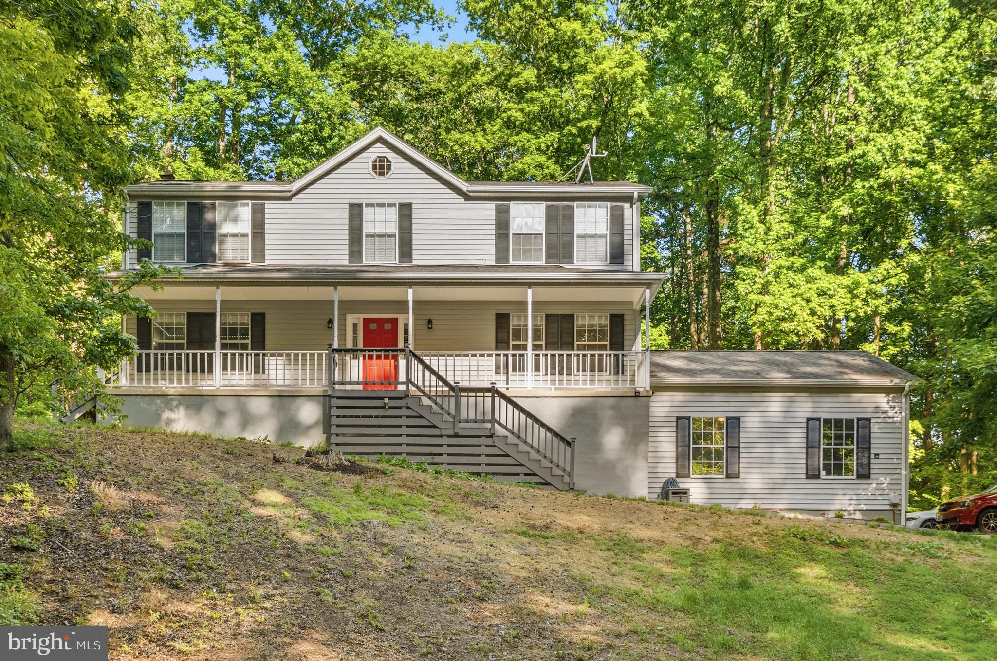 Stunning five-bedroom, three-and-a-half-bath Colonial situated on a beautiful partially wooded 3+ acre lot offering exceptional privacy and peaceful surroundings. Backing to a farm for added tranquility and scenic views, this spacious detached home welcomes you with a charming front porch and features a large two-car garage with tall ceilings, perfect for additional storage or workshop space.

Inside, the traditional floor plan blends timeless character with thoughtful modern updates. The beautifully updated kitchen showcases quartz countertops, stainless steel appliances, subway tile backsplash, and ample cabinetry, while luxury vinyl flooring flows throughout the main level. Gather around the beautiful wood-burning brick fireplace, creating a warm and inviting focal point for the main living area. The spacious primary suite features an en-suite bathroom designed for comfort and relaxation, while quartz countertops elevate the bathrooms with a modern touch. Step outside to enjoy the private rear deck overlooking the serene wooded setting — perfect for entertaining or quiet evenings at home.The finished walkout basement provides incredible flexibility with an additional bedroom and versatile flex space ideal for a recreation room, home office, gym, or guest suite. 
Extensive energy-efficiency upgrades demonstrate true attention to detail, including spray foam insulation in all exterior walls, aerosealed and insulation-wrapped ductwork, sealed attic joists, thermal attic zip barrier, and lighting thermal domes. Additional major updates include a newly installed HVAC system and high-efficiency Bosch water heater (2025).
Ideally located near the Patuxent River and public boat ramp, this exceptional property also offers convenient access to shopping, restaurants, and local public beaches along the Chesapeake Bay. Enjoy the perfect blend of privacy, comfort, efficiency, and outdoor lifestyle living in this truly special home.