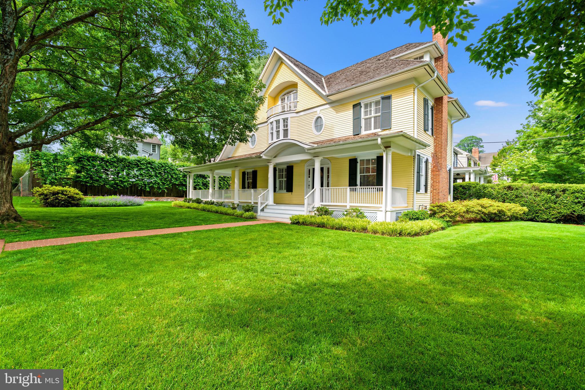 Welcome to this extraordinary residence, where timeless charm meets modern sophistication. Originally a 1920s Sears kit home, this property was masterfully transformed by award-winning architect Mark McInturff. While the traditional exterior maintains its classic appeal, the interior unfolds into an open, light-filled layout with clean lines, modern finishes, and exceptional craftsmanship.

Inside, soaring 9-foot ceilings and maple flooring create a warm and inviting atmosphere. A gracious center hall opens to a sunlit living room with a gas fireplace on one side and a spacious dining room on the other, which flows seamlessly into the custom family room and kitchen. The family room features exquisite maple cabinetry and built-ins, echoing the tone of the maple floors and offering direct access to an expansive 8-foot-deep wraparound porch—ideal for entertaining and everyday enjoyment. The kitchen is outfitted with high-end modern appliances and blends beautifully with the open floor plan. Built-in cabinets extend all the way to the ceiling, providing exceptional additional storage space.

Upstairs, the primary suite is a true retreat, boasting a sunny sitting area, a turret-like vaulted ceiling, generous closet spaces, a gas fireplace, and a spacious bath. A second bedroom—formerly two rooms—offers flexibility, while a hall bath and a BONUS room (ideal for a small office, laundry, or future third bath with existing plumbing) complete this level. See Virtually staged photos. for ideas. The top floor showcases two oversized rooms with vaulted ceilings, window seats, and abundant natural light from a dramatic third-floor skylight. A standout architectural element is the award-winning maple staircase with contemporary cable railing, which visually connects all three levels with elegance and light.

The lower level includes a Refreshed laundry area, Refreshed Storage Room/Playroom, workshop, and ample storage. Outside, the lushly landscaped lot is a private oasis with mature Plane Trees, Astor, Nepeta, and manicured lawn and hardscape—reflecting years of thoughtful care.

Set in the highly sought-after Section 5 of the Village of Chevy Chase, this home enjoys a rare blend of neighborhood charm and walkable amenities, just steps from La Ferme, Brookville Market, local shops, and two prestigious private clubs. Its location offers convenient access to both downtown Bethesda and Washington, D.C.—an exceptional opportunity in a truly magical setting.