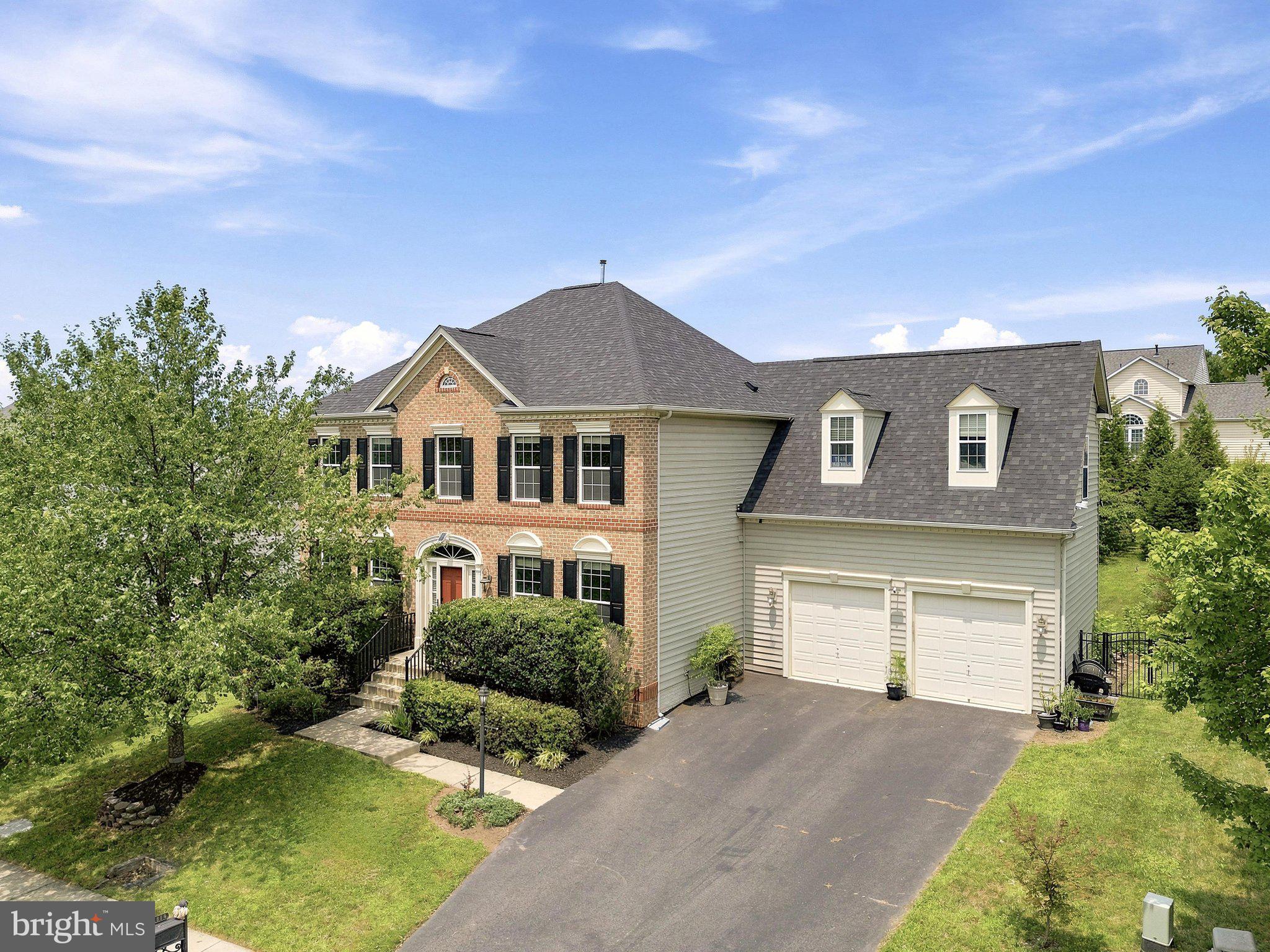 **Welcome to 21054 Hooded Crow Drive, Leesburg, VA 20175**—an exceptional **Abernathy model** nestled within the highly sought-after **Courtland Rural Village**, one of Leesburg's most picturesque and private communities. This elegant brick-front home offers **4,172 square feet** of beautifully finished living space on a fully fenced **0.30-acre** lot, blending timeless design, modern conveniences, and an outstanding Loudoun County location.
<p>
Designed for both comfortable everyday living and effortless entertaining, this spacious residence features **4 bedrooms, 4 full bathrooms, and 1 half bath**. The upper level offers four generously sized bedrooms, including a luxurious owner's suite, while the main level provides expansive living and entertaining spaces filled with natural light.

**Freshly painted and professionally touched up throughout, along with brand-new carpeting, this home offers a truly move-in-ready experience**, allowing its next owners to settle in and immediately enjoy all it has to offer.
<p>
The finished walkout lower level is an entertainer's dream, featuring a **dedicated theater room**, an oversized recreation room, a stylish **wet bar complete with its own refrigerator**, a full bathroom, and a versatile flex room currently used as a gym. With a closet and a window, this space can easily function as a **fifth bedroom**, guest suite, home office, or hobby room. The private rear entrance also creates an excellent opportunity for multigenerational living or future rental potential.
<p>
The heart of the home is the beautifully updated kitchen, featuring **appliances that are all less than four years old**, making it move-in ready for its next owners. Additional conveniences include **two full-size refrigerators**, with the second refrigerator located in the garage, providing extra storage for entertaining and large households.

This home has also been thoughtfully upgraded with today's lifestyle in mind. It is **pre-wired for a security system**, includes a **Level 2 electric vehicle charger** in the garage, and features an organized storage area with **custom shelving installed just three years ago**. For added peace of mind, the home is protected by a **30-year architectural roof that was replaced only two years ago**, offering years of worry-free ownership ahead.
<p>
Step outside to enjoy the spacious deck overlooking the private, fully fenced backyard—perfect for outdoor dining, relaxing, and entertaining. Garden enthusiasts will especially appreciate the **beautiful mature fig tree**, which produces fresh fruit each season, creating a unique and inviting backyard retreat. A **brand-new storage shed, still in its original unopened packaging, will also convey with the home**, giving the next owner the opportunity to install additional outdoor storage wherever they choose.
<p>
Located in the highly desirable Courtland Rural Village, residents enjoy the perfect blend of privacy and convenience. Surrounded by scenic countryside, yet only minutes from historic downtown Leesburg, you'll have easy access to award-winning wineries, breweries, local restaurants, shopping, parks, and endless outdoor recreation. Commuters will appreciate the quick access to **Route 15, Route 7, Battlefield Parkway, and the Dulles Greenway**, making travel throughout Northern Virginia simple and convenient.
<p>
Offering generous living space, flexible floorplan options, extensive recent updates, and an exceptional location, **21054 Hooded Crow Drive** is a rare opportunity to own a beautiful home in one of Leesburg's most desirable communities. **With its thoughtful upgrades, move-in-ready condition, and versatile layout, no detail has been overlooked—making this an exceptional place to call home.**