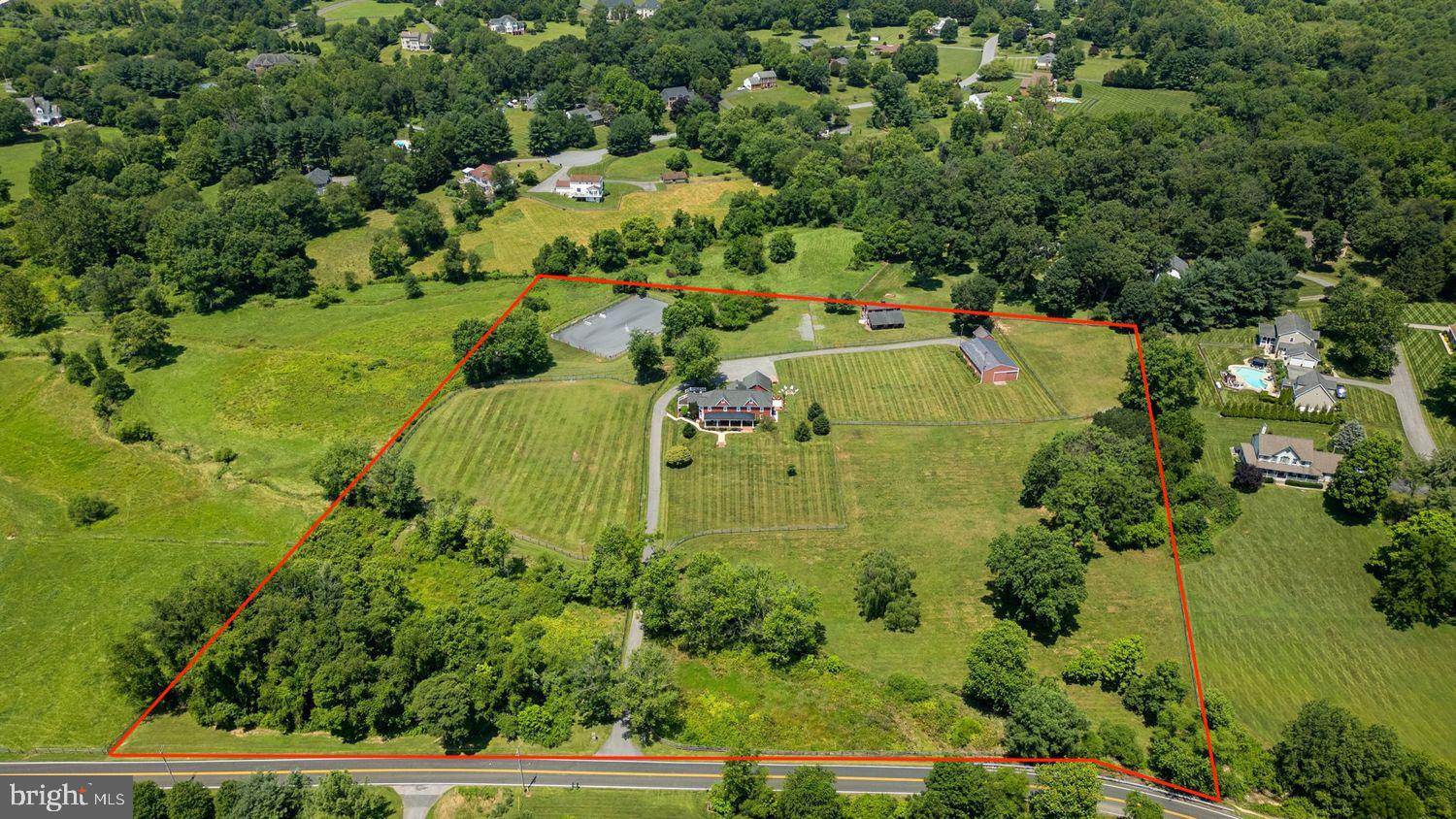 This is the ONE. The entire package. Welcome to Compass Hill Farm, an exceptional equestrian estate located in the heart of Howard County. This 5-bed, 3.5 bath, 4224 sq ft home sits on 10.3 acres of lush pastures, landscaped grounds, and natural beauty. A true turn-key equestrian facility that reflects thoughtful design, care, and maintenance. The property is zoned for blue ribbon schools and within easy access of dining, shopping, and entertainment. All this within 45 min to DC, 30-minutes to Baltimore and 15-minutes to Columbia.

The expansive, gorgeous farmhouse reflects rustic authenticity in an atmosphere of refined living. The home is an entertainer's delight, with a large open-concept kitchen and floor plan that centers around the home's showpiece mid-19th century log cabin "heart." Multiple French doors, custom millwork, and over 40 large windows fill the home with light and allow 360-degree views of the property. Take in the seasons from the expansive front porch and watch your horses graze, backlit by stunning sunrises and sunsets. Set back from the road, and buffered by an idyllic meandering stream and riparian habitat, the home and farm offer a refuge of beauty and peace for both horse and human.

The discerning equestrian enthusiast will enjoy a 2013 Mennonite-built 5-stall center-aisle carriage barn with heated, custom-built tack room, hot/cold wash rack, large hay loft, rubber bone-paver aisle, and farm-grade, ceiling-mounted fans in each stall. Three-board fenced pastures are optimized for all-season sustainability with upgraded heavy-use areas and heated automatic waterers. A state-of-the-art, all-weather, 100’ x 150' laser-graded riding arena with a bluestone base topped by premium rubber/sand arena footing and a bridle path allows for versatile and year-round schooling. A 40' x 60" pole barn with water and electric offers versatile options for leisure or business. Surrounded by renowned competition venues, world-class clinicians and trainers, and thriving local US Pony Clubs, this estate offers it all. Experience the beauty and serenity of this special estate today.