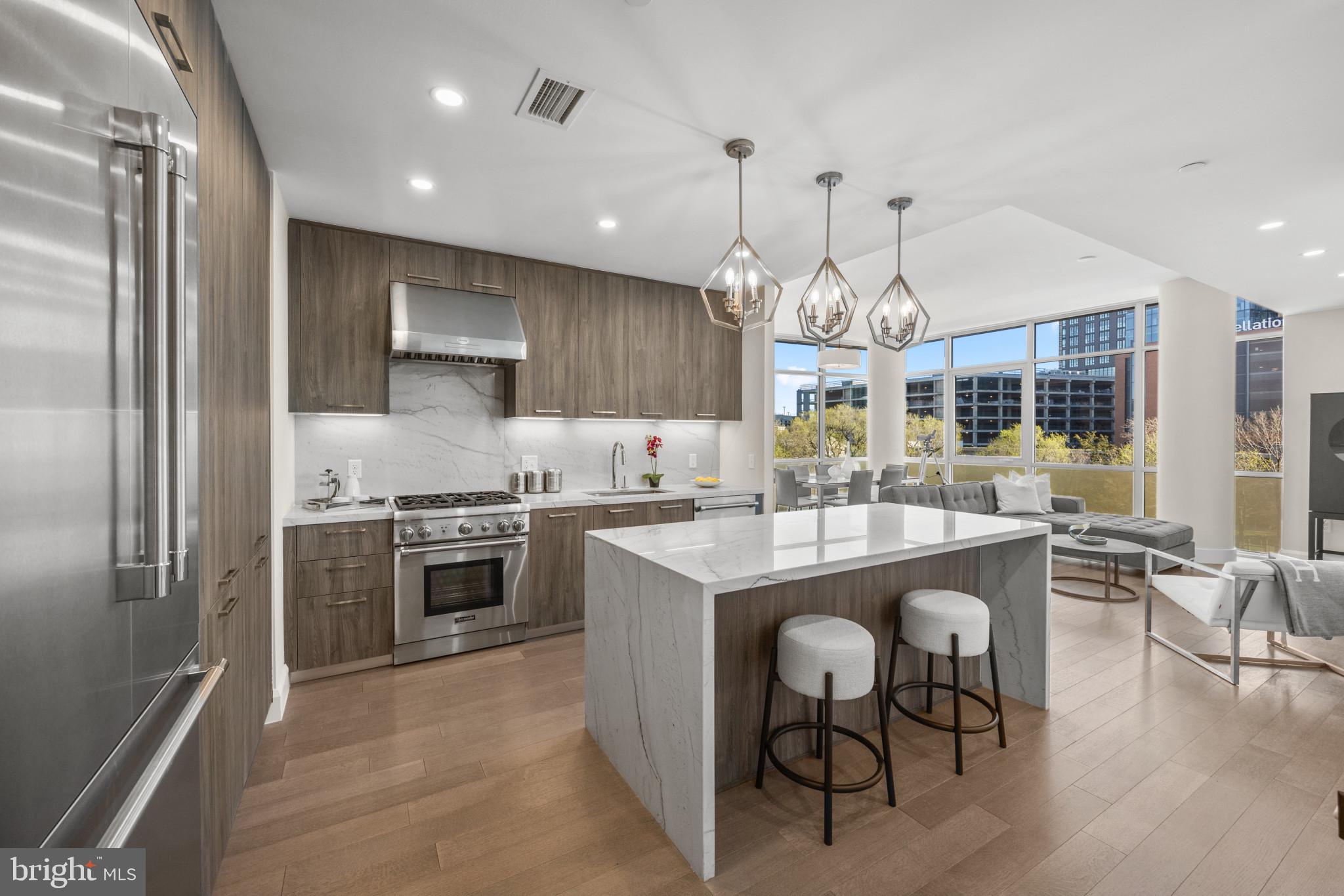 Welcome to the epitome of luxury living at Liberty Harbor East. This exquisite two-bedroom condominium boasts unparalleled elegance and sophistication. Spanning 1,200 square feet, this corner condo is bathed in natural light, accentuating its impeccable design and captivating views through floor-to-ceiling windows. Step into a chef's paradise with the state-of-the-art open kitchen, featuring Italkraft custom cabinetry and top-of-the-line Thermador appliances, including a 4-burner gas range and MicroDrawer microwave. The expansive waterfall stone island seamlessly integrates with the entertainment space. Retreat to the primary bedroom suite, complete with a walk-in closet and a spa-like master bathroom adorned with Kallista & Kohler fixtures, Carrara marble floors and walls, and a luxurious dual vanity. New construction 5-year tax phase-in applies. Liberty Harbor East stands as Baltimore's premier luxury waterfront destination. With 33 condominiums, this boutique condominium offers unparalleled waterfront architecture and designer finishes. Nestled atop the brand-new flagship Whole Foods Market, it promises the epitome of downtown living.Residents indulge in an array of exclusive amenities, including a private Concierge level, social lounge, secured package room, and ButterflyMX intercom security system. Additionally, over 30,000 square feet of private indoor and outdoor spaces await, featuring a clubroom with indoor/outdoor bar, rooftop infinity pool deck with cabanas, courtyard seating, grilling stations, communal and private dining rooms with catering kitchen, fitness center, yoga studio, pet park, conference rooms, and a study lounge with computer stations and the opportunity to experience the ultimate downtown lifestyle at Liberty Harbor East, surrounded by Harbor East's finest dining, shopping, and urban conveniences.