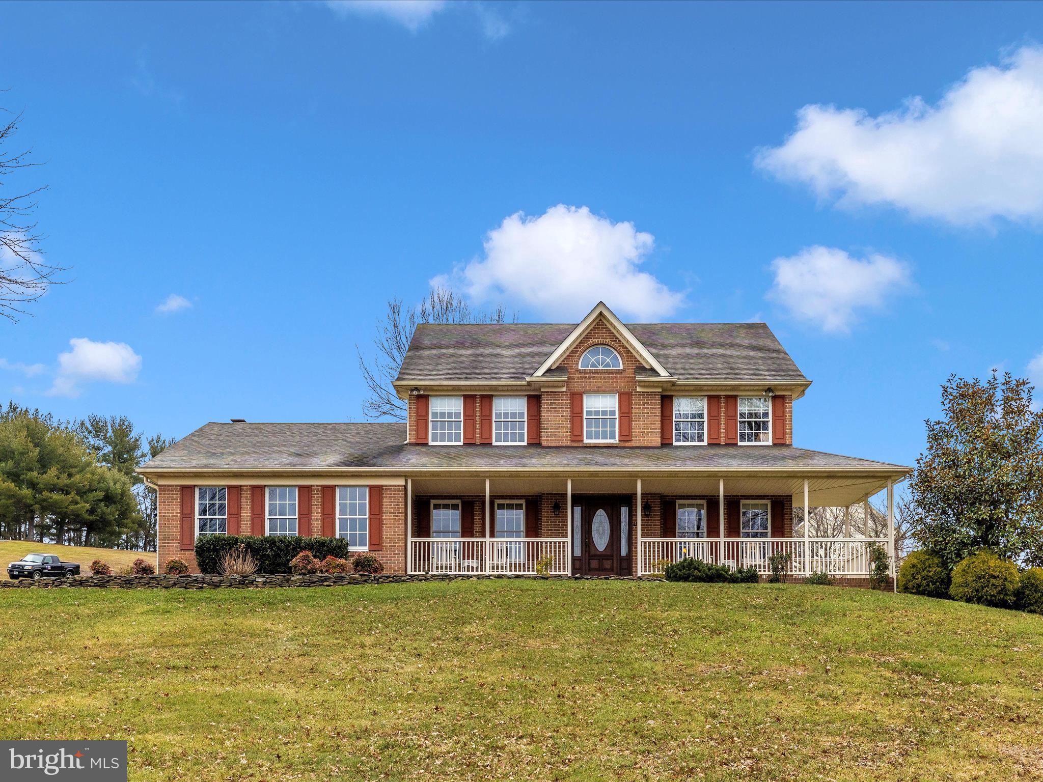 A Million Dollar View & Location accompany this absolutely gorgeous home! It is beautifully situated on a tended 4.6 Acre Lot, with a wrap-around front porch and a screened in back porch, deck and shed.  From the moment you enter the spacious hardwood foyer, you will feel the quality and see how impeccably this home has been cared for. Lovely main level office with built-ins greets you off the foyer, as does a formal living room which opens to the formal dining room. The formal dining room is open to the gourmet kitchen which flows into a breakfast area and family room. The family room boasts a masonry wood-burning fireplace with a woodstove insert and access to the screened rear porch and deck. The gourmet kitchen features granite counters, top-of-the-line cabinetry, backsplash and stainless appliances. Also on the main level - a powder room and a HUGE laundry & mud room with entry into the 2 car garage. The Upper Level has 4 bedrooms: Extra Large Primary Bedroom with Completely Updated Slipper-tub Bath with Double Vanity and Double Walk in Shower plus a Walk In Closet. The hall bath has been updated too! The extra special: A Hall Walk-in Closet and TWO Hall Linen Closets! On the lower level, there is an open L-shaped Rec Room with level walk out to the side yard, a roughed in bathroom, plus a spacious utility and workshop area. 2-Zone HVAC system w/Humidifier. Generator Hook-up!