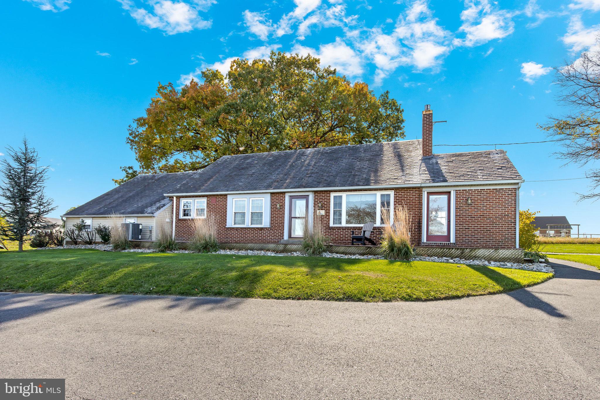Adorable 5 bedroom solid brick Cape Cod home with breathtaking farmland view for miles.  3 first floor bedrooms and 2 on 2nd floor.  Large eat-in country kitchen with granite countertops, loads of cabinets, and pantry.  Formal dining room with built-in corner cabinet, chair rail, and crown molding.  1st floor family room with propane brick fireplace.  Mud room.  1st floor laundry room.  Another 1st floor office/sunroom.  2.5 bathrooms.  Full basement waiting to be finished.  Garage plus shed with electric service.  Circular driveway.  All of this and more on 3/4 acre lot.