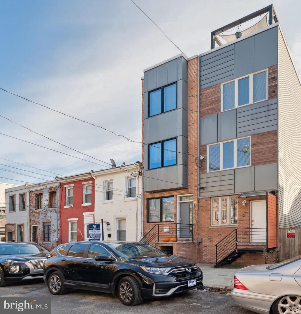 Welcome to this contemporary 4 bedroom, 3 bathroom home at 2405 Coral St in Fishtown. Built in 2016, this home is a perfect blend of modern design and functional living. The interior showcases an open-concept layout, flooded with natural light, emphasizing the sleek finishes and high-end details. The finished basement adds a versatile dimension, providing an ideal space for a bedroom, home office, entertainment room, or gym. The three well-appointed bedrooms offer ample space and comfort, with plenty of storage space. Ascend to the rooftop deck to discover a stunning outdoor oasis, complete with a pergola and wet bar. This elevated space not only provides a serene escape but also offers breathtaking views of the neighborhood and city skyline, perfect for hosting gatherings or enjoying quiet evenings with a glass of wine. Nestled in the heart of Fishtown, this home allows for easy access to the neighborhood's vibrant dining scene, trendy boutiques, and artistic community. The convenience of modern living awaits you in this meticulously crafted residence. Schedule your viewing now! Photos are from previous listing.