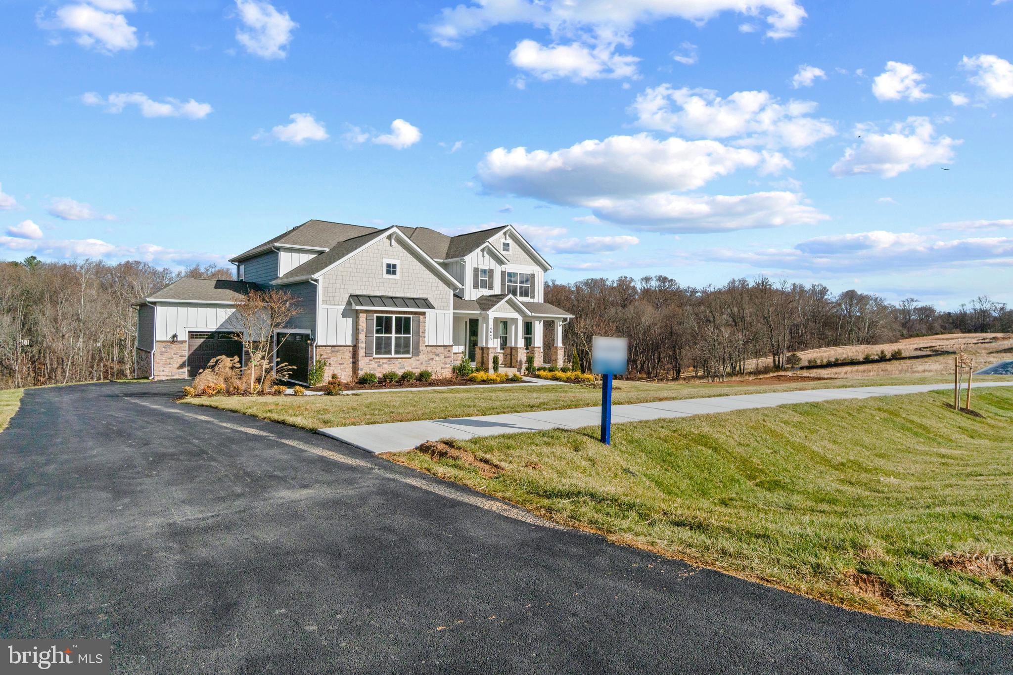 Immediate move in available! New home for the new year! Country meets luxury living on this sprawling 1.4 acre, 5 bed 4.5 bath home that backs to conservation area. The "Vanderbilt" features a 1st floor primary bedroom suite with tray ceilings, and a spa inspired bathroom with dual vanity, frameless shower, separate garden tub, and oversized walk-in closet. The primary bedroom leads out to a back covered porch with a breezeway to the kitchen. The chef's kitchen features quartz waterfall countertops, cooktop, stainless steel built-in microwave oven, soft close cabinets, optimal pantry storage, and dedicated casual dining area. The 2-story foyer opens to a flex space that is usable as a home office or formal dining. Laundry room located off the 3-car side load garage. The 2-story living room features a total of 8 windows facing the private backyard space, giving optimal opportunity for natural light. The oak staircase walks up to the loft with engineered wood floors throughout all the hallways; 3 bedrooms and 2 full baths (one en-suite), complete the second floor. Basement includes a finished rec room, bedroom and full bathroom. Price listed is for final, complete home. January closing available. Ask about our financing incentives! 
 *Photos not of actual home, and are of a similar model*