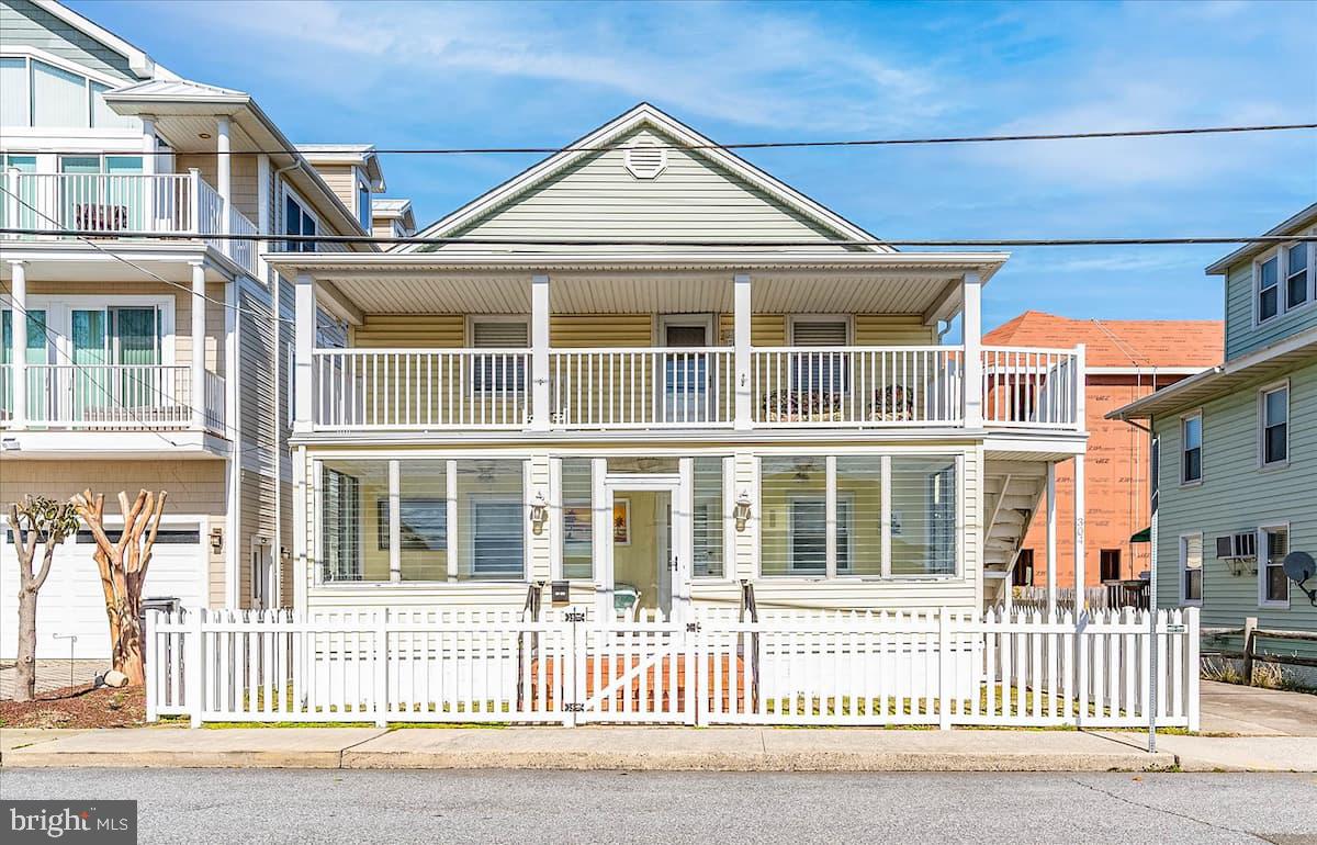 Rare opportunity to own a direct bayside waterfront 2-unit property in Downtown Ocean City, just blocks from the beach, boardwalk, dining, and attractions. The property features two separate units: a 3BR/3BA first-floor unit and a 2BR/1BA second-floor unit, offering flexibility for multi-generational living, extended family use, personal enjoyment, or rental income. There may also be potential for additional living space or rental income through the detached garage, pending zoning and other applicable approvals.

Both units feature remodeled kitchens with granite countertops, custom cabinetry, tile backsplashes, and separate washers and dryers. Enjoy beautiful canal and bay views from the sunroom, balcony, and large waterfront composite deck. Additional highlights include 2 private boat slips, outdoor space for entertaining, and a detached garage for storage of all your beach and boating gear. With approximately $110,000 in annual rental income over the past two years, this is a rare waterfront opportunity with exceptional versatility.