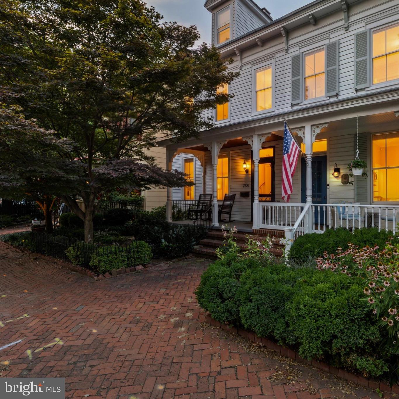 Nestled along one of the most prestigious streets in Historic Annapolis, 268 King George Street presents a rare opportunity to own a beautifully renovated residence just steps from the U.S. Naval Academy, St. John's College, City Dock, Main Street, Spa Creek, and the Chesapeake Bay. Offering the perfect blend of historic charm and sophisticated modern living, this exceptional home places you at the center of everything that makes Downtown Annapolis one of Maryland's most desirable destinations.

A welcoming covered front porch sets the tone for the home, providing the perfect place to relax, greet neighbors, or enjoy the charm of one of Annapolis' most iconic streets. Inside, timeless architectural details, including rich heart pine floors, soaring ceilings, elegant moldings, and oversized windows, are beautifully complemented by thoughtful, high-end renovations.

Designed for both everyday living and effortless entertaining, the main level features elegant formal spaces, including a gracious dining room anchored by a beautiful fireplace and a spacious living room filled with natural light. The gourmet kitchen is appointed with premium appliances, custom cabinetry, generous workspace, and opens seamlessly to a sun-filled four-seasons room, creating an inviting gathering space for family and friends.

Upstairs, the luxurious primary suite offers a peaceful retreat highlighted by two walk-in closets with custom built-in organization systems, providing exceptional storage rarely found in Historic Annapolis homes. The beautifully renovated bathrooms showcase designer-inspired tilework, custom vanities, and sophisticated finishes that blend timeless style with modern comfort.
Additional bedrooms offer generous accommodations, while the private third-floor suite provides the ideal space for guests, a home office, fitness studio, or additional living area.Outside, a beautifully landscaped courtyard offers remarkable privacy and a tranquil setting for outdoor dining, entertaining, or quiet evenings in the heart of downtown.

From your front door, enjoy easy access to award-winning restaurants, boutique shopping, waterfront parks, marinas, sailing, museums, galleries, and the vibrant energy of City Dock. Whether you're looking for a full-time residence or an exceptional Annapolis retreat, 268 King George Street offers an extraordinary opportunity to experience luxury living in one of Maryland's most treasured historic waterfront communities.