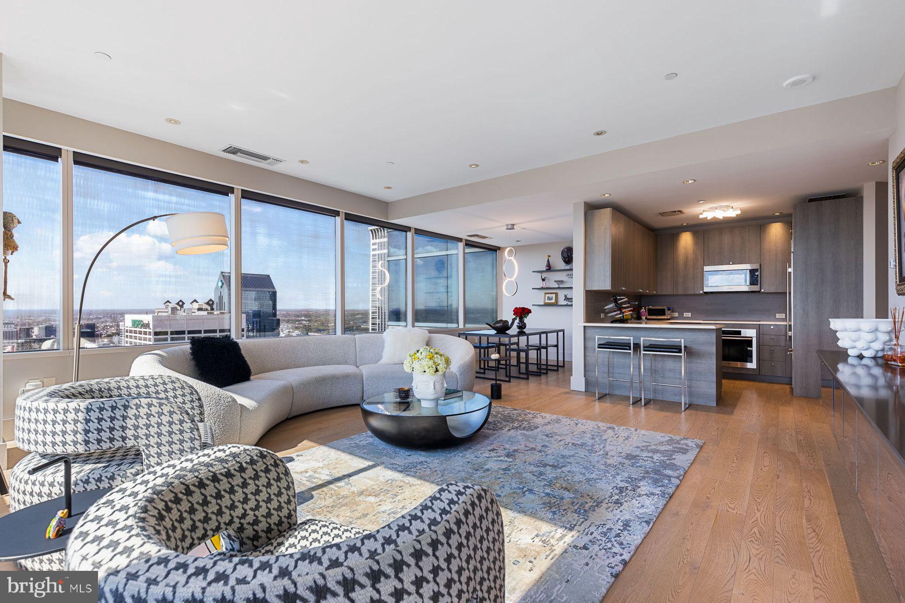 Experience elevated living in this exceptional corner condominium at the prestigious Two Liberty Place. Bathed in natural light, this one-of-a-kind unit features walls of windows, offering stunning views to the South and West. Thoughtfully designed with a sleek modern aesthetic, yet warm and inviting, this residence boasts two en suite bedrooms plus a separate den/office. Every space feels special, and ample, but especially the primary bedroom suite where you can relax and wind down the day. Indulge in top-tier amenities, including a state-of-the-art fitness center, a chauffeur-driven town car, 24/7 doormen, concierge services and so much more. For an additional charge, valet parking is available for as many cars as you need. Pets are welcome and the building is perfectly situated in the heart of the city. This is urban luxury redefined.