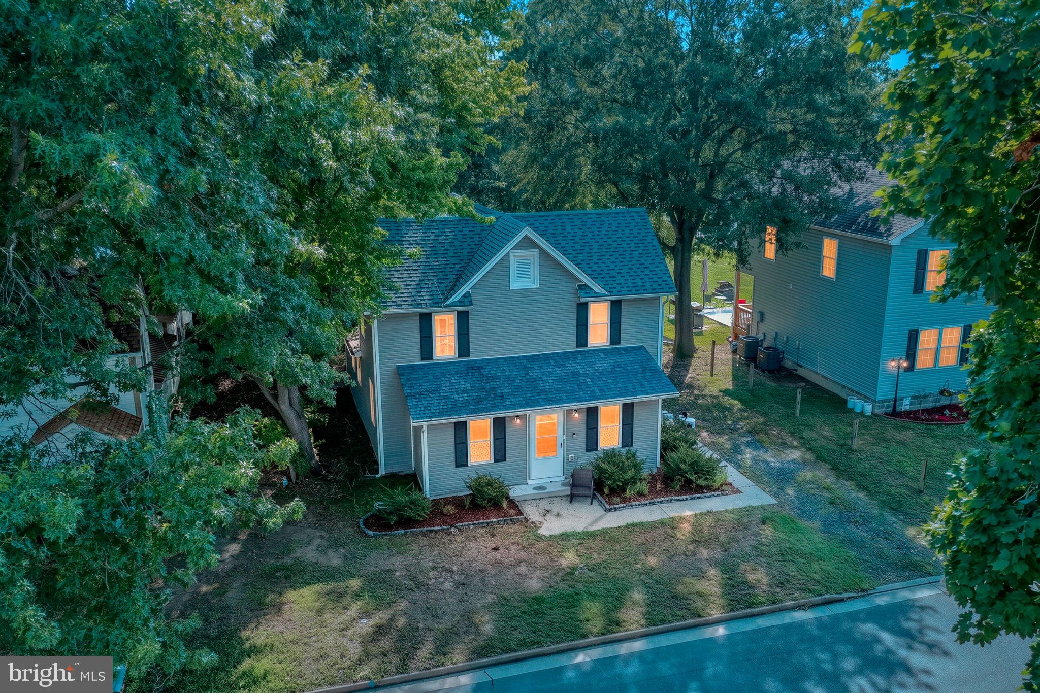 Charming updated Farmhouse style home with hardwood floors throughout and tiled bathrooms. The open kitchen features quartz countertops, a center island for extra prep space and casual dining, stainless steel appliances, and a tile backsplash. The first floor includes a full bath with a tiled walk-in stall shower, plus a separate laundry/mud room. Dual-zone heating and air for year-round comfort. Major updates completed in 2021: new windows, plumbing, electrical, and LED lighting,  Sliding doors open to a large backyard with a patio and a new storage shed. Located less than a block from the park, offering a playground, skate park, walking trails, ball fields, and tennis and basketball courts.