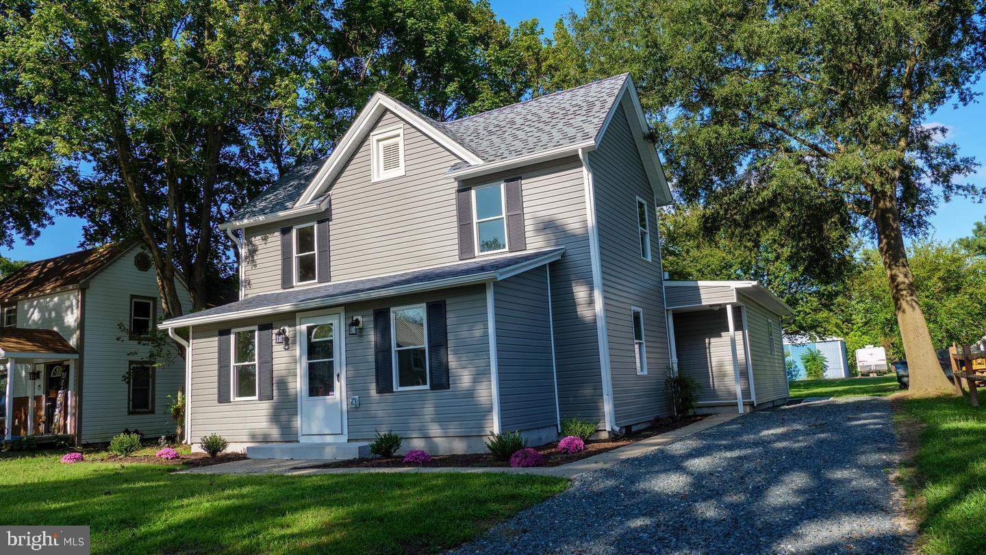 Charming updated Farmhouse style home with hardwood floors throughout and tiled bathrooms. The open kitchen features quartz countertops, a center island for extra prep space and casual dining, stainless steel appliances, and a tile backsplash. The first floor includes a full bath with a tiled walk-in stall shower, plus a separate laundry/mud room. Dual-zone heating and air for year-round comfort. Major updates completed in 2021: new windows, plumbing, electrical, and LED lighting,  Sliding doors open to a large backyard with a patio and a new storage shed. Located less than a block from the park, offering a playground, skate park, walking trails, ball fields, and tennis and basketball courts.