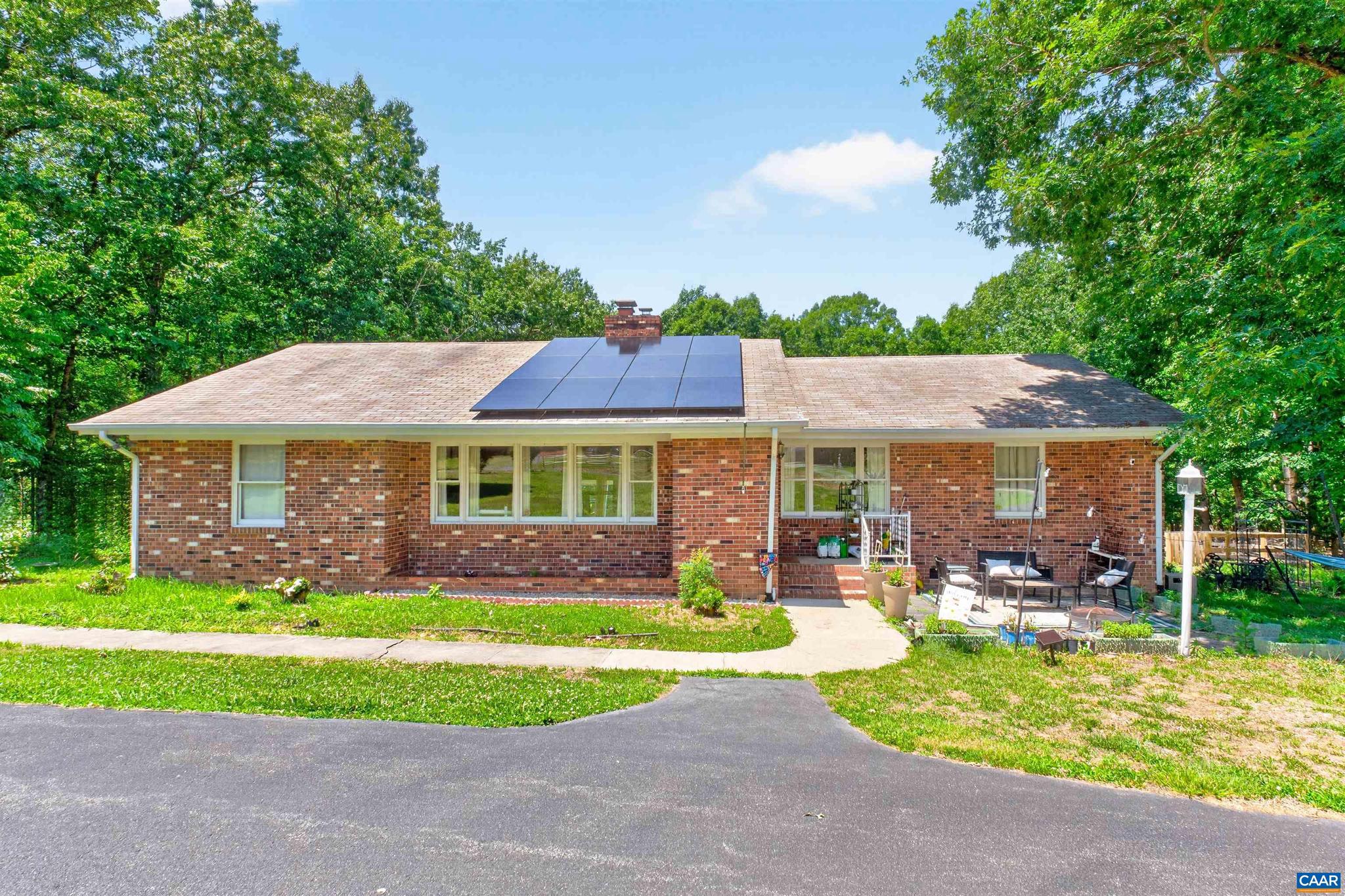 Well-maintained brick ranch on 2 private acres just 15 minutes from Charlottesville, UVA, and downtown. Spacious one-level living with formal living and dining rooms, family room with fireplace, huge rec room, primary suite with private bath, and two additional bedrooms. Enjoy the large fenced backyard, storage shed, and paved circular driveway. Recent updates include HVAC (2025), well pump and hot water heater (2022), updated plumbing, solar panels, heat pump with backup propane heat, and generator. Convenient access to I-64.