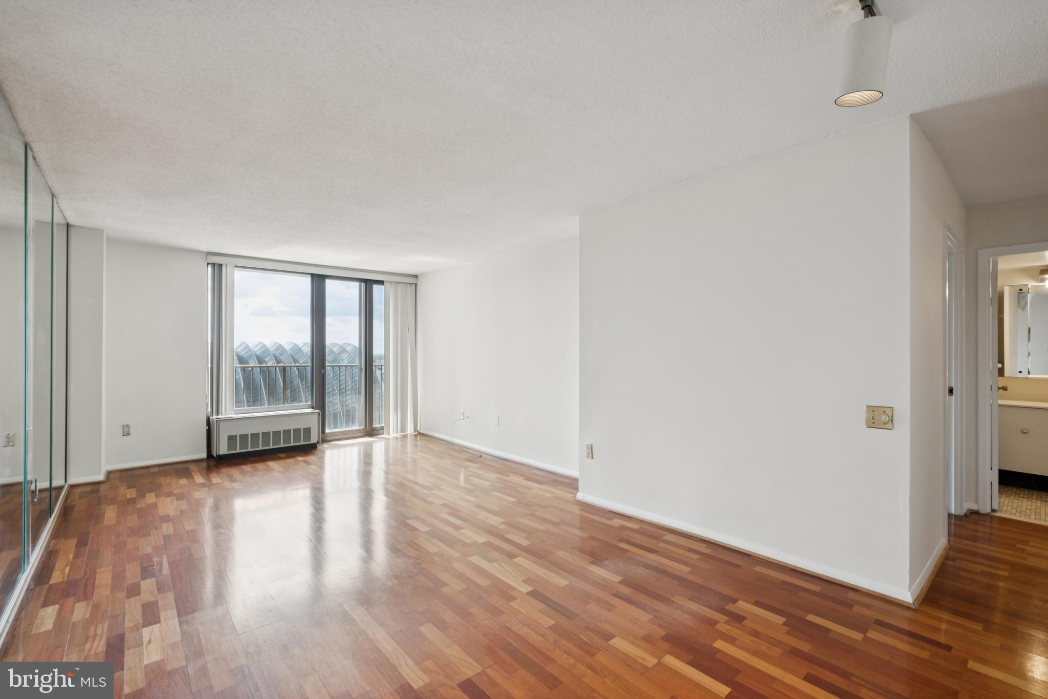 Spacious, south-facing one bedroom with a private French balcony at Academy House. Enter through a foyer with coat closet into the sun-soaked great room showered in light from oversized windows with ample space for living and dining and access to the French balcony boasting southern city views. The fully equipped, galley-style kitchen has ample cabinet and counterspace, white appliances, and a tile floor. The spacious bedroom enjoys beautiful natural light from an oversized window, a large wall closet, and a walk-in closet. Adjacent is the bathroom with large white vanity, tub shower, tile floor, and laundry closet with stacked washer/dryer. There is excellent closet space and hardwood floors throughout. Residents of Academy House enjoy a 24-hour doorman and a state-of-the-art fitness and aquatic center. There is valet parking in the building's garage for an additional monthly fee, subject to availability. The Academy House is located in the heart of Center City and within close walking distance to Rittenhouse Square, Washington Square, and the Broad Street and Market Street office corridors. The Philadelphia International Airport and Amtrak's 30th Street Station are easily accessible.