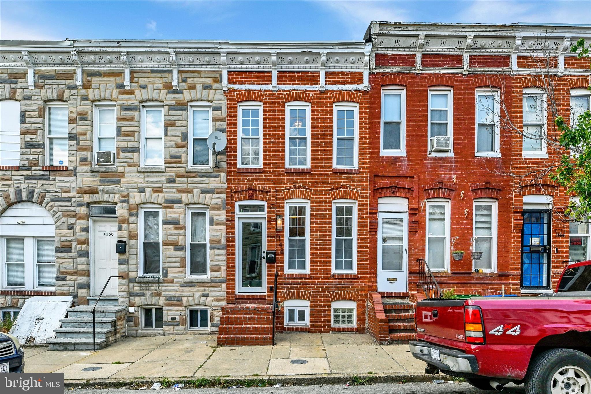 Welcome to this beautifully updated Pigtown rowhome where classic Baltimore character meets modern comfort. Just renovated from top to bottom, this home features two brand-new bathrooms, new appliances throughout, new flooring, and a fresh coat of paint that makes every room feel bright and move-in ready.

Step inside to discover stunning exposed brick and an open staircase that anchors the space with timeless warmth and personality. Out back, a new deck and fenced yard create the perfect setting for morning coffee, weekend grilling, or unwinding after the game—plus a rear parking pad that leads right up to the new deck, giving you the convenience of off-street parking, a rare and welcome find in the city.
And speaking of games—location doesn't get much better. You're just a short walk from both M&T Bank Stadium and Oriole Park at Camden Yards, putting Ravens and Orioles game days right at your doorstep. Living in the heart of Pigtown means you're steps from local favorites along Washington Boulevard, with quick access to downtown, the stadiums, and everything that makes this historic neighborhood one of Baltimore's best-kept secrets.

Whether you're a first-time buyer, a growing family, or a die-hard sports fan, 1148 Sargeant St is ready to welcome you home.