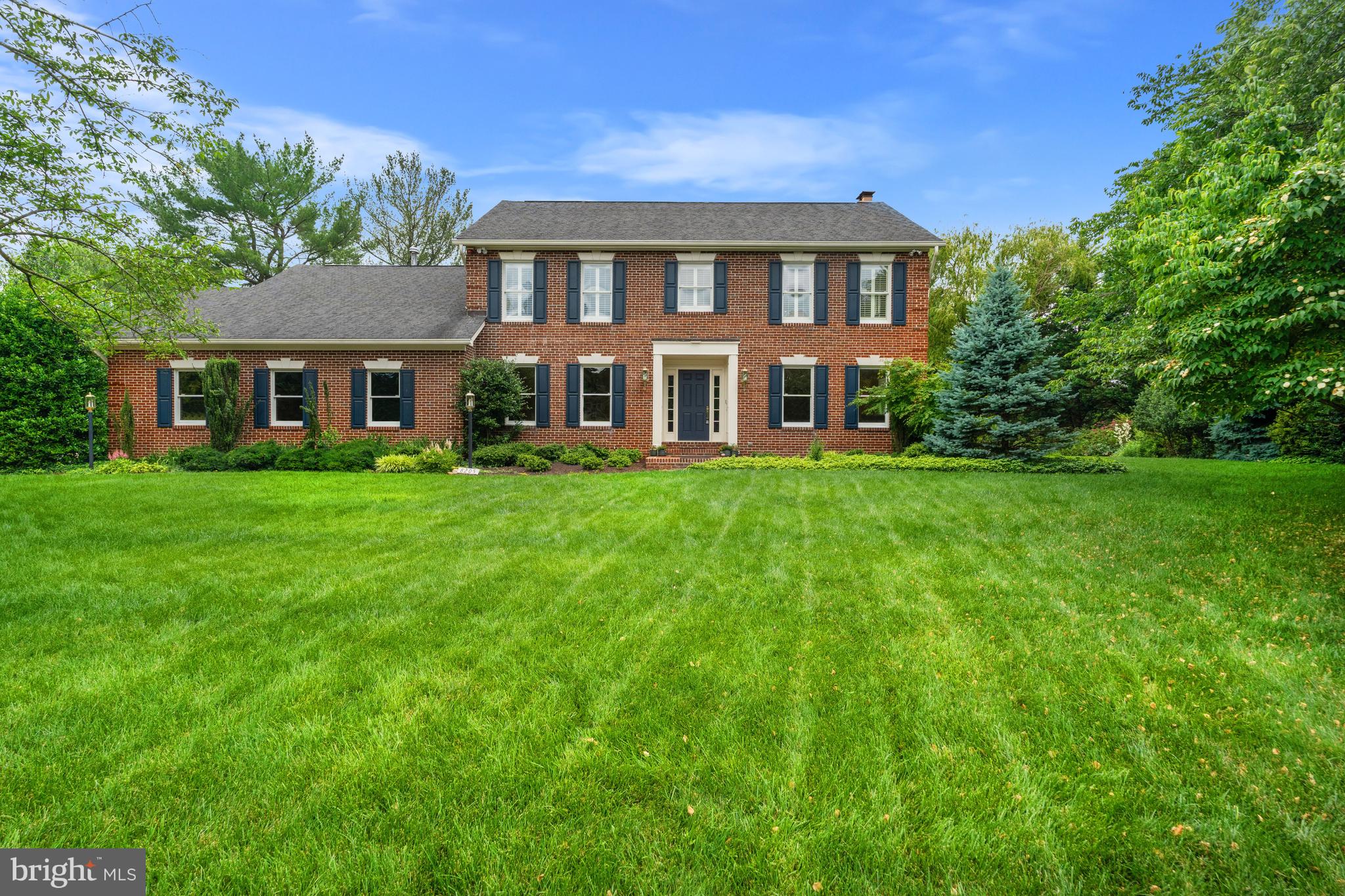 Settled in a quiet cul-de-sac, this beloved Condon Manor home offers a classic brick exterior and a 21st century interior, well-appointed for family living. This 1991 Federal has been tastefully renovated throughout its three levels and 4,850 square feet of living space with luxury fixtures and finishes including hardwood and stone flooring; custom cabinetry; marble and granite countertops; and recessed LED lighting throughout. The priority given to energy efficiency and air quality informed, but never compromised, every design decision. 

Welcome home to a broad expanse of greenery, an elongated driveway, and a landscaped walkway. Talk about curb appeal.  Two lighted dusk to dawn lamp posts guide your guests towards a large porch and recessed doorway. 

Or enter your home via your attached, side-loading, oversized 2-car garage into the family foyer hallway connecting the laundry room and den with an ensuite shower bath, ideal for presenting the best 2 (or 4) feet forward to the kitchen, family dining and living areas overlooking an expansive and private back yard. 

Guests entering the lighted front door would find an elegant foyer with Italian marble flooring and be invited to enter the living room to the right, for conversation and a view of the evergreen side yard from the bay window.  Or, guests could proceed to the center of the home, to enter the family living area with a bay window overlooking the backyard and its woodland edge with access to the kitchen, bar seating, and gathering area.  A third option from the foyer is the large dining room to the left through elegant double glass paned French doors and seating for up to 12 friends and family.  These double doors are mirrored by the same double glass paned doors leading from the dining room to chef's kitchen, and a view of the range hood designed by Cheng for Zephyr.  

The chef's gourmet kitchen is the heart of this family home for a cook who likes tech. Sub Zero refrigerator.  Wolf range.  Bosch dishwashers. Grohe faucet, Viking microwave, Viking warming drawer, and Sub Zero wine refrigerator.  Any home chef will feel like a professional while they cook on any of the six burners of a double oven range with a grill.  The sports enthusiast will not miss a play on the television above the fireplace, while they are preparing meals for their family.  

This kitchen was designed to host large parties as well. From the kitchen, and the family area, there is an open and effortless flow to the backyard through the single door, flanked by door-sized windows, to the brick patio and beyond.

The second floor offers an open area providing access to the hall bath, and three additional bedrooms.  two of the bedrooms are larger, separated by a walk-in linen closet. Separation from the primary suite between the two larger bedrooms invites use of the fourth, smaller bedroom as flex space that spans generations, useful as a nursery, office or sitting room.  

The primary suite features a Cathedral ceiling, daylight and privacy. The adjacent walk-in closet is similar in size to the bath and has doors to both. The spa bath includes dual vanities, dual medicine cabinets and large shower with steam, jets and a rain shower. The toilet enclosure has frosted glass and its own lighting and fan. The free-standing tub by Bain Ultra has heated seats and a freestanding faucet. The primary bath and the other two baths, renovated in 2015, include floor heaters; the floor of the master shower has additional insulation and lighting. 

The lower level recreation room offers built-ins, a fireplace, a wet bar and back patio access. The lower level is complete with a bonus room, an unfinished storage room and full bath. Take advantage of the summer weather on the back patio, surrounded by the private backyard; the ideal al fresco dining setting.

In close proximity to local parks, Spring Hill Rec Center and Tysons Corner, 8205 Falstaff Road is a vision of residential bliss!