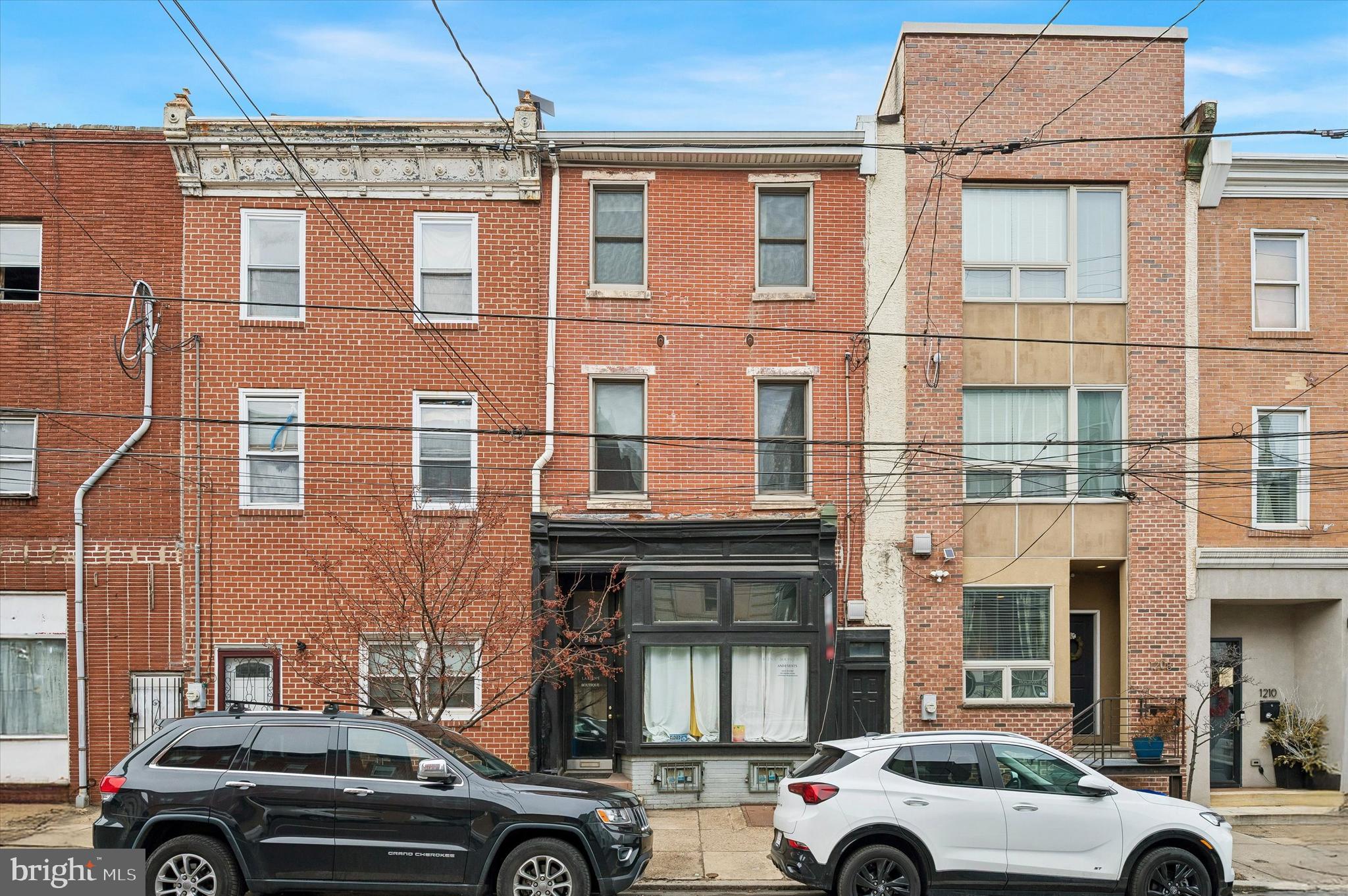 1206 N 5th Street is a fully occupied, income-producing 4-unit mixed-use building in the heart of the thriving Northern Liberties/Olde Kensington corridor, featuring 1 commercial storefront, 1 studio apartment, and 2 one-bedroom units, plus a shared outdoor space and basement with common laundry. All utilities are separately metered, except water and those powering the laundry, helping to control operating expenses. The property offers a strong 10.5% cap rate, so you generate income on day one. The new price reflects some capital improvements that are needed to sustain the building for the next 100 years! All leases are currently month-to-month, providing flexibility to renovate and increase rents as units turn over or to pursue owner-occupancy if desired. The residential units offer enormous ceilings and excellent natural light, and the commercial space features a traditional storefront façade without the burden of a historical designation. Lead-Safe Certificates for all three residential units, Rental License, Fire Alarm Certificate, and leases will be provided to the Buyer for their review after their offer is accepted. Located just steps from Girard Avenue and a few blocks from the shops and restaurants at the Piazza and along Frankford Avenue and Front Street. Convenient access to the Market-Frankford Line for an easy commute to Center City and beyond, this high-visibility location continues to attract entrepreneurs and renters alike, making it an exceptional opportunity for investors seeking immediate cash flow with long-term upside.