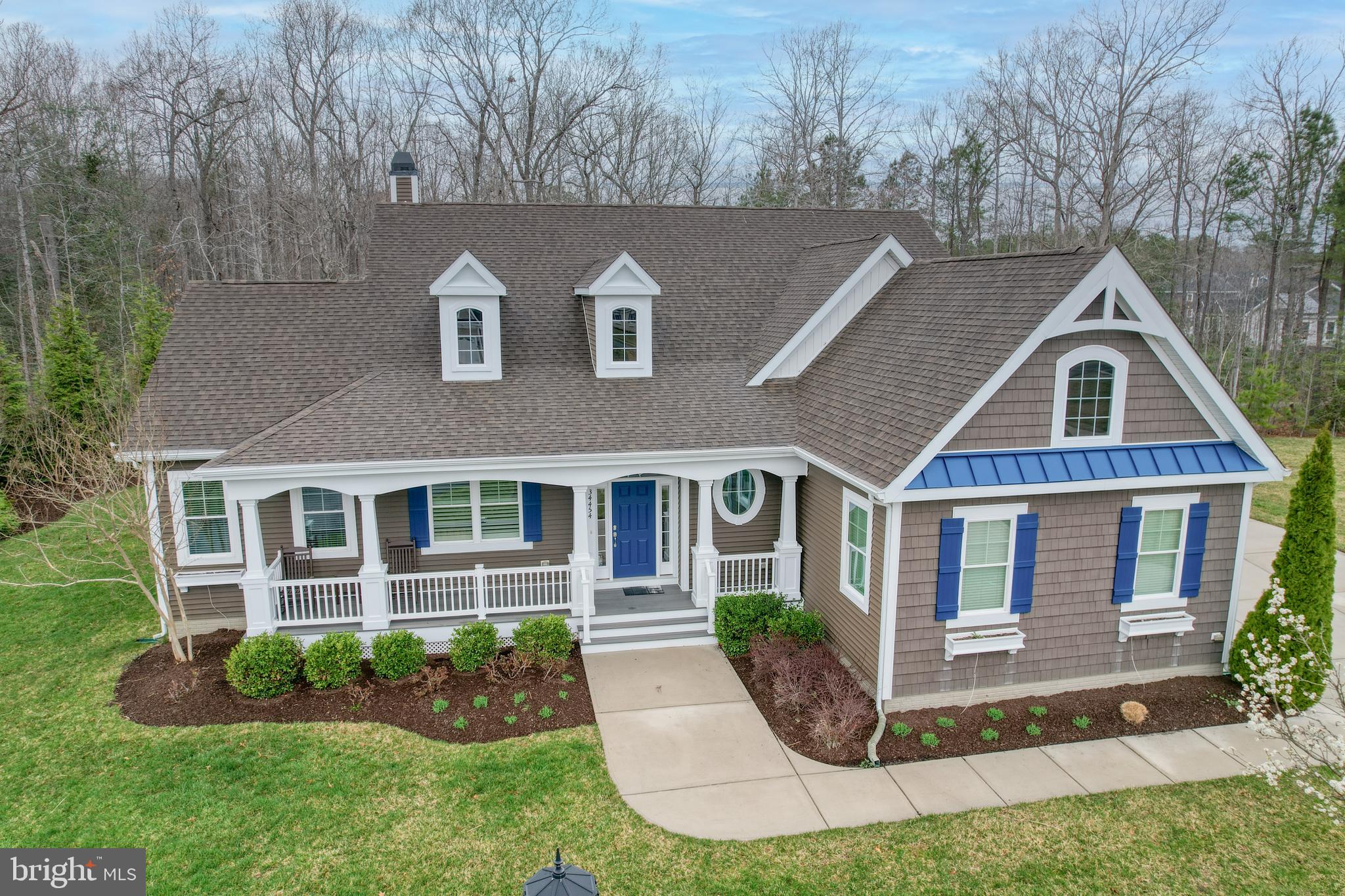 Unique opportunity for a private cul-de-sac home in the popular Tidewater landing (TWL) community.  Lot #205 is a 15,506 sf. ft. lot (.3586), one of the largest in TWL.  This Mayberry model home has been expanded and customized and boasts upgrades throughout.  Featuring a three-car side entrance garage, the extended garage, the extended driveway and parking pad can accommodate an additional 5-6 cars. The house itself has hardwood floors throughout the open concept living area.  The formal dining room can easily be converted into an office or bedroom.  The Professional kitchen features granite countertops, an oversized island and a custom pantry. The great room offers a linear fireplace for cozy winter nights. The master bedroom suite enjoys an extended bay window facing private woods, custom his and her closets, separate sinks, an oversized shower and a soaking tub. Hard to believe you are just a short drive to the Lewes beaches, the ferry, and Cape Henlopen State Park, in this peaceful and secluded home.   This home offers two more bedrooms, another full bath and a powder room on the first floor, as well as a custom laundry room with oversized washer/dryer.  Upstairs enjoy a grand bedroom/bathroom suite with a huge walk-in closet and an unfinished storage area.  The kitchen dining area has been expanded to provide a quiet sitting area to enjoy the seclusion of the wooded backyard.  A screened porch opens  onto the paver deck which offers a gas stub for grill and a conduit for electric power.  This gem is a short walk to the clubhouse/gym/patio gathering space, pool and mailboxes.  Other TWL amenities include robust social activities, dock/kayak launch on Love Creek, a kayak rack, well maintained walking trails , tennis/pickle ball courts and a children's playground
