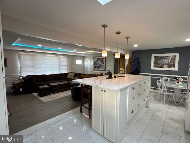 This beautiful high-end renovated home  located in the desirable community of Severna Gardens in the heart of Severna Park features 4 bedrooms and 3 full custom ceramic tile bathrooms.  Walking distance to Severna Park High School.  Custom features through-out highlighted by your stunning gourmet, open kitchen.  Waterfall-style, quartz 4 person kitchen island with tons of cabinets space.  Large, Master bedroom with ensuite bath.  Big, living room with fireplace and recessed lighting and custom windows that provide lots of natural light.  Walk-through your sliding Wood barn doors into your fully finished basement.  This space is HUGE with a custom-built bar that is perfect for entertaining friends and family.  4th. bedroom in basement with full bath.  Plenty of storage space in your laundry room with full size washer and dryer.  Relax  in your breezeway porch or back yard patio and enjoy your coffee and paper in the morning and cocktails in the evening.  Comes partially furnished, if needed.  This home has it all!