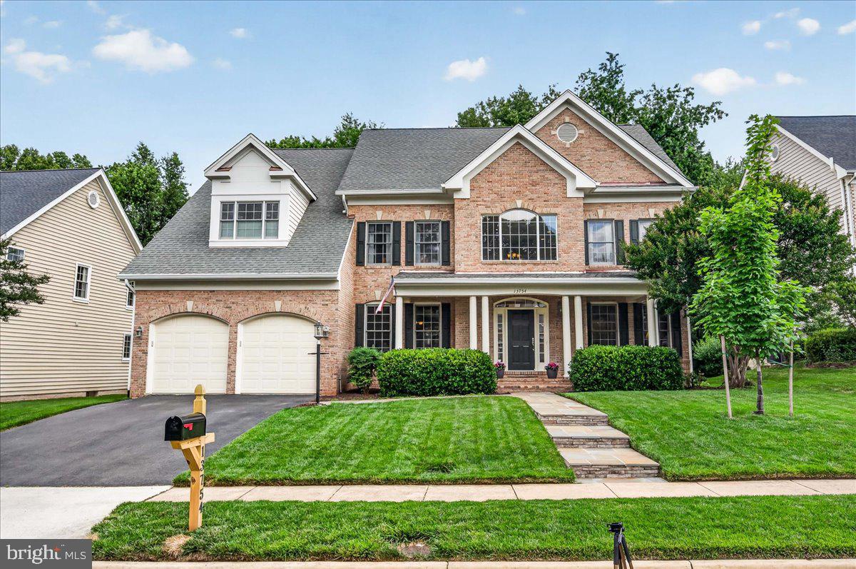 OFFER DEADLINE 3 PM 6/11. Step into a home that immediately feels grand, open, and thoughtfully designed for everyday living as well as memorable gatherings. A two-story foyer with a curved staircase sets the tone, while LVP flooring flows throughout the main level, connecting elegant formal spaces with comfortable everyday rooms. The dining room features crown molding and chair rail, offering a polished setting for dinners and celebrations, while the formal living room can also serve beautifully as an additional office, framed by a wall of windows, recessed lighting, and one side of a dramatic two-sided fireplace. On the other side, the family room soars with a two-story wall of windows, filling the space with natural light and creating an inviting place to unwind by the fire. The kitchen is designed to be the heart of the home, with granite countertops, 42-inch cabinets, mostly stainless-steel appliances, a 5-burner gas cooktop, double wall oven, oversized island, desk area, walk-in pantry, and a second rear staircase for added convenience. A glass-door office, powder room, and mud/laundry room with utility sink complete the main level. Upstairs, the open hallway overlooks the foyer and leads to a spacious primary suite with plush carpet, dual walk-in closets, and a beautifully finished bath featuring dual vanities, a wet room with herringbone tile, a water closet, and a large linen closet. A true retreat! Three additional bedrooms, all with ceiling fans, include one ensuite and two connected by a Jack-and-Jill bath with double sinks. The lower level expands the living space with a recreation room/game area and separate TV room, both with recessed lighting. There is also a full bath with stall shower, a legal bedroom with walk-up access to the backyard, space for a home gym, plus unfinished storage. Outside, enjoy a neighborhood rare front porch, screened-in porch with ceiling fan, Trex deck, and a large yard backing to trees for a peaceful outdoor retreat. Pair this lovingly cared-for home with a location close to shopping, restaurants and major commuter routes, there is nothing left to say but Welcome Home!
