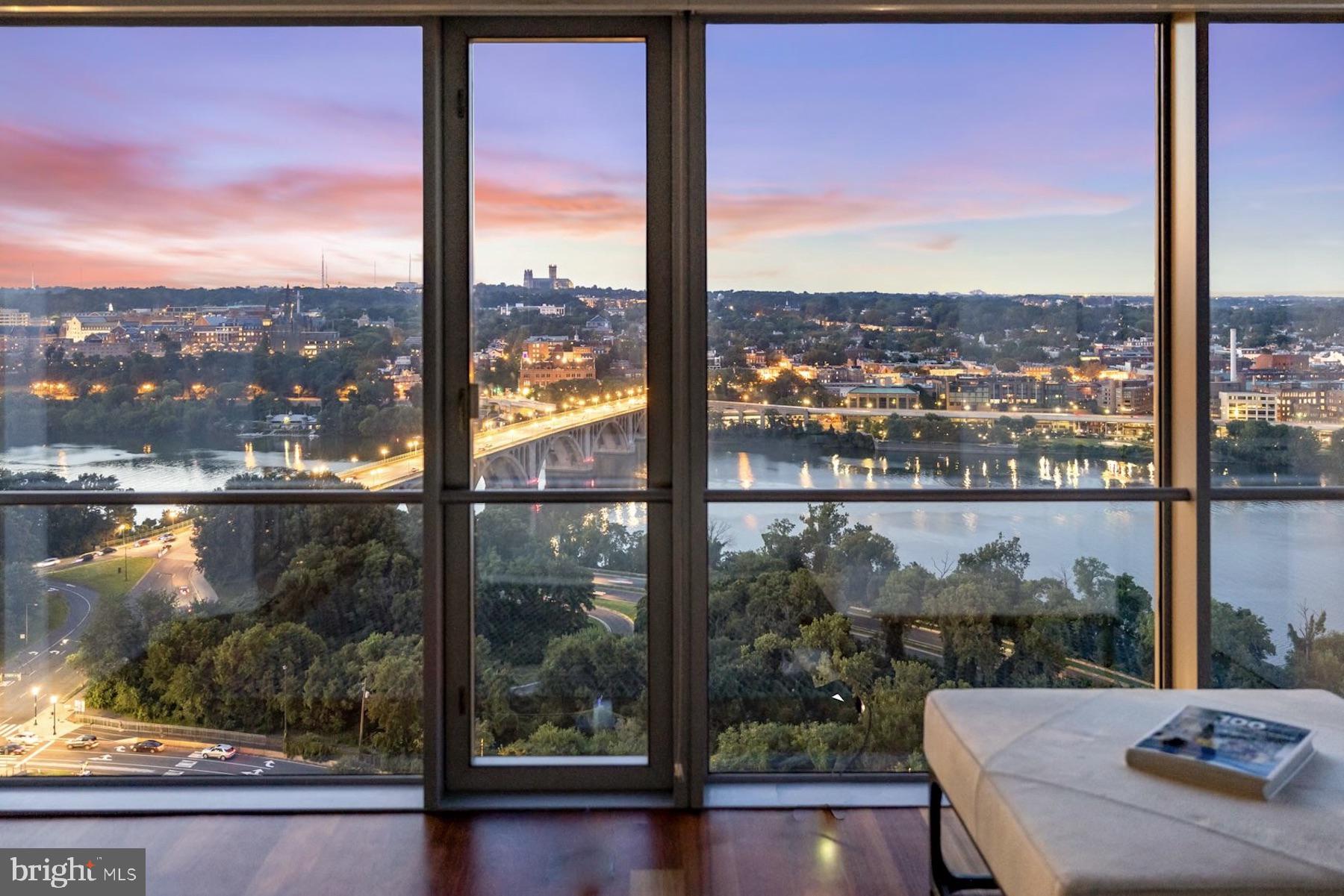 This spectacular 3-bedroom Waterview residence offers commanding, jaw-dropping views of the Potomac River, Key Bridge and the monuments from virtually every room. Giant wraparound windows and richly-hued hardwood floors are complemented by exquisite finishes and built-ins by designer Joseph Ireland. Invite friends to watch July 4th fireworks over the water from your private space or on the incomparable 31st floor observation deck! Living, dining, and cooking areas merge seamlessly in this airy and open perch in the sky. A chef-caliber gourmet kitchen is replete with granite counters and Viking, Sub-Zero, and Miele appliances. Private quarters include a memorable owners’ suite with vestibule, a floor-to-ceiling wall of windows, a huge dressing room with custom organizers, and a showcase ensuite marble bath. All three bedrooms have spectacular water views, plus the flexibility to use them as a work-from-home space if you choose. Enjoy the convenience of an in-unit laundry room, powder room, and two garage parking spaces. Hotel-style amenities include front desk, concierge, room service from the popular downstairs Amuse at Le Meridien restaurant, a state-of-the-art fitness center, health spa, and a phenomenal rooftop observation deck with two outdoor kitchens, lounges and postcard-perfect panoramic views. Walk to neighborhood shops and restaurants, the nearby Metro, or across the bridge to Georgetown! A true five-star lifestyle experience.