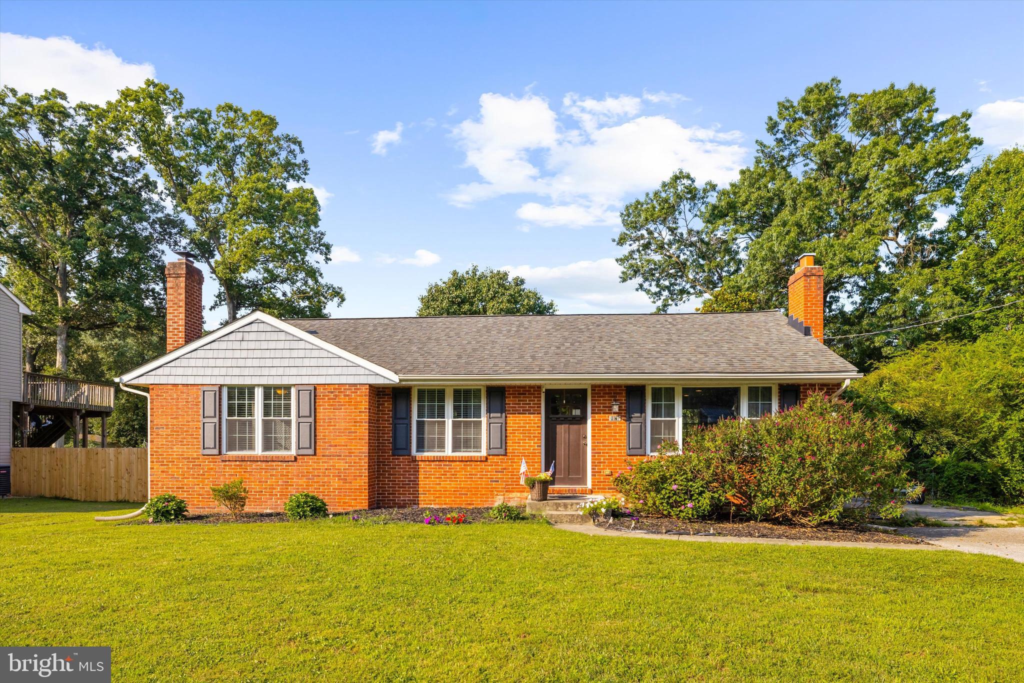 Welcome home to 8028 Woodholme Circle in Pasadena, a beautiful brick rancher tucked away on a low-traffic street in the heart of Anne Arundel County.
Inside, the open-concept living area feels bright, warm, and welcoming with large windows, hardwood flooring throughout, and a classic brick fireplace that anchors the space. The kitchen offers a great mix of style and function with granite countertops, stainless steel appliances, a custom tile backsplash, and plenty of cabinet space for everyday living.
The main level also includes a comfortable primary bedroom with two closets and a private ensuite bathroom, plus two additional bedrooms with access to a full hall bath. The unfinished basement (basement ceiling height 6 ft 5 in) adds even more flexibility, whether you need storage, a home gym, workshop, hobby area, or room for future possibilities. Out back, mature fig and cherry trees are already established and producing, adding something special to the fully fenced backyard, while the fire pit area creates the perfect spot to enjoy evenings outside.
With easy access to major highways, shopping, dining, and everyday conveniences, this Pasadena rancher offers comfort, charm, and a wonderful place to call home.