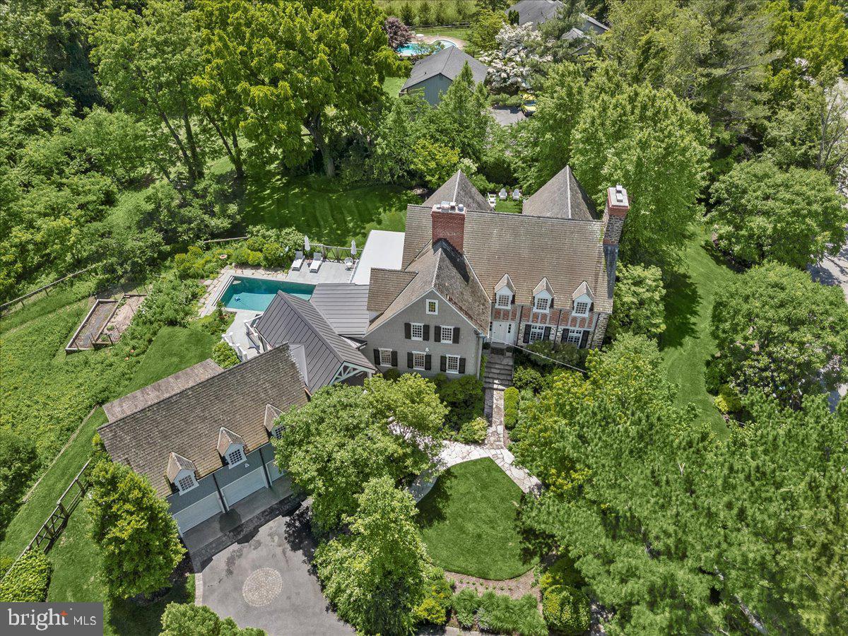 A restored historic farmhouse graces the top of Skywater Road on Gibson Island.  Built in 1810, Islecrest is the oldest standing home on Gibson Island. Located on more than an acre, with four levels, this special six bedroom, five full and two half bath home is a wonderful gathering place for family and guests. 
Enter the front door to a bright and airy hallway with a soft painted checkerboard pattern on the floor.  An inviting eat-in kitchen opens to a simply magnificent outdoor porch perfect for entertaining, connecting the main house and the guest house.  A powder room is conveniently located on the main level in the kitchen. A large dining room with gas fireplace and beautiful crown molding is to the right of the front door, and a glorious sunporch overlooks the backyard with pool and garden with magnificent plantings.  French doors open to a stunning living room with a large woodburning fireplace flanked with wide plank heart of pine floors.  A comfortable den opens to the dining room, offering serene views, exposed stone walls, a flagstone floor, and built -in bookcases.  
Ascend a gracious staircase upstairs to a landing where to the left is a laundry room hidden behind closeted doors, and an en suite bedroom.  The landing leads to an en suite bedroom and an office on the left, and to the right is the primary suite with full bath and sitting room.  On the third level is a bedroom, full bath, and bonus room.   The lower level has a family room, half bath, and sunporch opening to the heated swimming pool with bluestone surround. 
A gardener’s delight, flowering trees, shrubs and perennials surround the property. There is a dahlia cutting bed and three vegetable gardens. A tree house beckons the young at heart.
The guest house above the three-bay garage has a sitting room, two bedrooms and a full bathroom.
Information on Gibson Island:
Gibson Island is a private island within one hour of Washington, D.C. and Baltimore offering an absolutely extraordinary setting.  The Island comprises 1000 acres with seven miles of shoreline. Two thirds of the Island is undeveloped and is owned by the Gibson Island Corporation, the homeowners' association.  The remaining third is residential home sites. 
Gibson Island is located on the western shore of Maryland, so there is no need to cross the Bay Bridge. On the Island is a 43-acre spring fed freshwater lake in which one may enjoy non-motorized watercraft activities such as paddleboarding, canoeing, kayaking, fishing and swimming.  
The Island offers enormous privacy and security--there is an entry gatehouse staffed 24+Hours and the Island is patrolled by the Gibson Island Police Force (GIPD).  The Gibson Island Corporation Service Department offers yard maintenance and landscaping and other services for homeowners.  There is a full-service yacht yard.   From the Island, it is just a 20-minute drive to BWI Airport and the neighboring Amtrak train station.  
The Island houses a private country club (membership by invitation) offering yachting, fine dining year-round, tennis, an award-winning Charles Blair Macdonald designed 9-hole golf course, swimming, croquet, skeet shooting, and more.  (C)