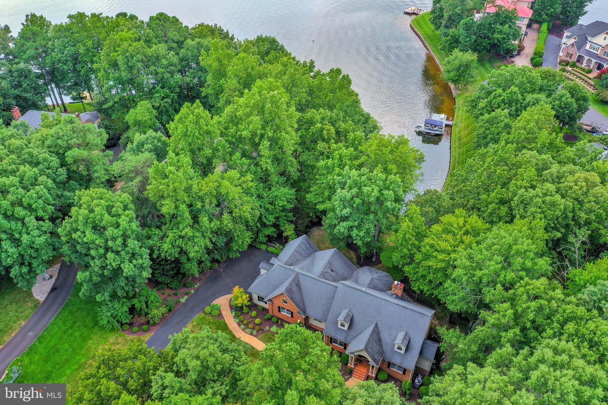 Cove lakefront sitting on 1.32 acres this three level custom built residence is  an artistic combination of traditional and open contemporary lifestyle  design elements. The warm-hued wood and window wall construction are the embodiement of its  casually elegant presentation.  It is so worth your time to  appreciate this gem through its photos . A special feature sheet  is in the document area for your access.
The blueprint of this residence shows nearly 6000 sqft of indoor, outdoor, finished & unfinished potential living area. Over 2300 sqft comprises its  open, spacious, 10ft ceiling main level. comprised of these rooms: 2 story wide foyer, separate dining room, living room, sitting or sun room, eat-in kitchen with walk in pantry, laundry , conveniennt half bath,  bedroom with two walk in closets & an on-demand steam shower bathroom. The common areas are hard wood and tile, the bedrooms are carpeted.  On the upper level there are two en suite dormer bedrooms & a loft overlook. The lower level finished rooms that open onto an arched column brick patio are an office ( which has a hidden closet desk center) an  excercise room including mirrored wall and a richly appointed retreat which has been used for collectibles, & crafting. One of the closets of this room is equipped as a sewing and paint center! A cedar walk-in closet and half bath complete the finished rooms. There is more than ample space for conversion of the half bath to a full one.  The unfinished areas have such potential. Right now the rec room area has proved  a great asset when lakeside activities spill indoors.  All of the rooms facing the backyard have a view of the cove.  The screen porch with built-in grill as well as the full covered brick arched  patio overlooking the lawn to the lake enhance entertaining & outdoor living opportunities.
Families of all ages call this amenity-rich neighborhood of Fawn Lake home as it offers a secure environment and all of the spaces for one's hobbies such as cycling, swimming, running, tennis, pickleball, paddle board,  fishing, baseball, soccer, volleyball,  & boating,  Amenities also include an Arnold Palmer designed golf course & club, Community Clubhouse, social center,  marina, fitness center, pool, restaurants, dog park, playgrounds, walk trails, friendly security, & a maintenance staff that  reasonably clears the snowy roads as needed! There are civic, social , study, Veteran & game club gatherings, etc. The premium benefit of Fawn Lake's location is its rural setting surrounded by  National Park lands within minutes of farm markets,  a local winery & brewery, restaurants , commercial strip centers full of local businesses & conveniences.