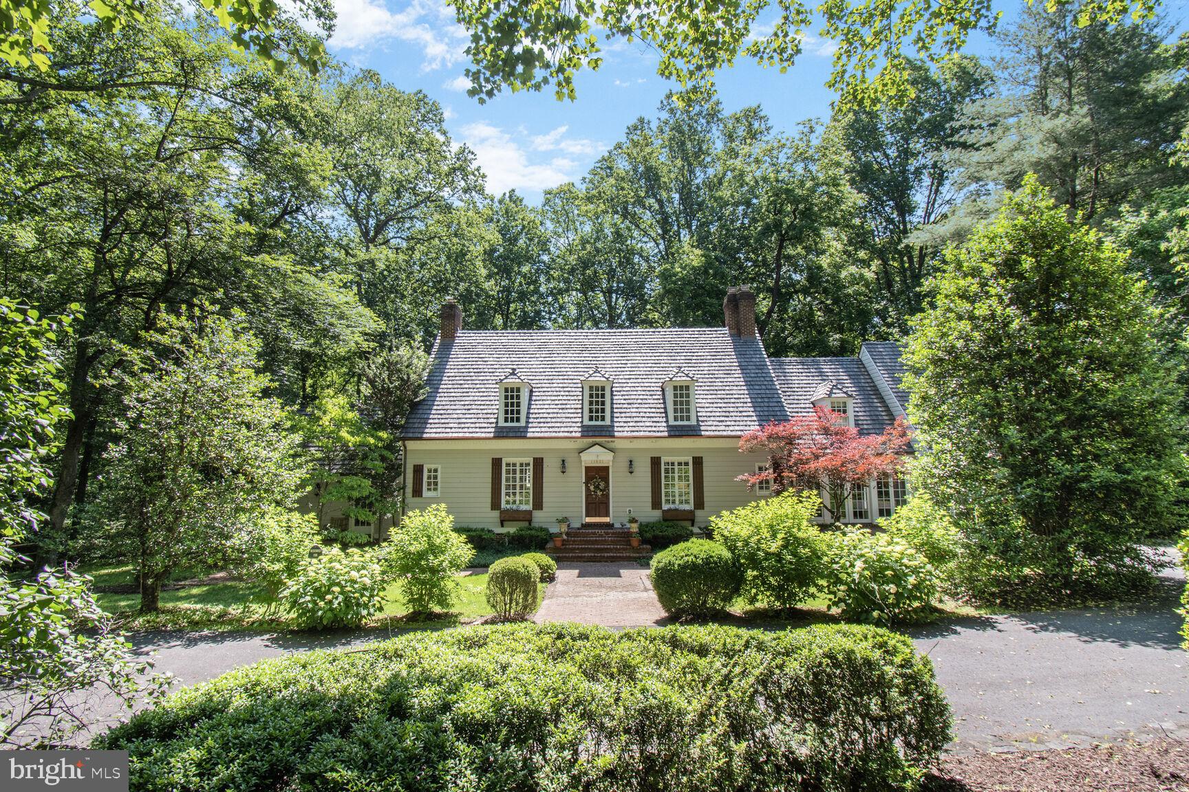 OPEN SUNDAY 1 TO 4P.M. This property is an exquisite example of a Williamsburg Colonial home built by renowned builder Brendan O’Neill. It offers 4,500 square feet of refined living space featuring antique brick, 5" pine floors, Delft-tiled fireplaces, Chinese Chippendale railings, and character-filled details throughout. Historic charm meets modern updates in the renovated Kitchen, which includes granite counters, custom millwork cabinetry, Viking appliances, a Sub-Zero refrigerator, farmhouse sink, and wine fridge. The main level offers multiple living spaces including an amazing Family Room with Cathedral beamed ceiling, stone fireplace and built-in wet bar; an elegant Dining Room; Sunroom; and additional Sitting area/Study with enhanced by crown molding, built-ins, and multiple fireplaces. The home embraces indoor-outdoor living with two deck spaces accessed by the Family Room and Sunroom—perfect for entertaining or relaxing. Upstairs, the spacious Primary Suite boasts pine floors, large windows, ample closet space, and a luxurious Full Bath with a spa-like tub and double vanity. Three additional Bedrooms, 2 more full Baths, and a charming office or sitting room complete the upper level. The finished Lower Level includes another Bedroom, Full Bath, walk-in cedar storage closet, and access to the backyard. Set on 1.25 acres, the property is ideal for avid gardeners or anyone who enjoys peaceful forest scenery.