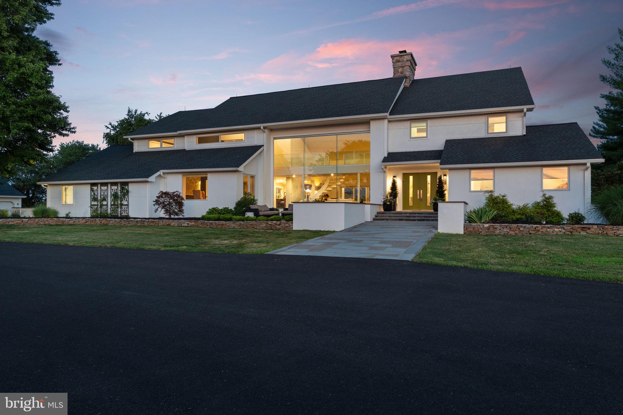 An Architectural Statement. A Private Retreat. A Home Without Compromise.

Set amid 11.2 breathtaking farmland-assessed acres, where morning sunrises paint the eastern sky and evening sunsets create a spectacular backdrop from the front of the home, this extraordinary custom contemporary residence represents a fusion of architectural sophistication, craftsmanship, and luxury. Completely rebuilt with attention to every detail, this is more than a residence—it is a modern estate designed for those who appreciate an effortless living.

Clean architecture and expansive walls of glass create an unforgettable first impression while seamlessly connecting the interior to the surrounding landscape. Every space has been intentionally designed to maximize natural light while showcasing panoramic views.

At the center of the home, the well though out chef's kitchen is both a culinary workspace and showpiece. Premium Thermador appliances include a professional-grade refrigerator and freezer, six-burner gas range with griddle, double ovens, steamer, warming drawer, dehydrator, wine refrigeration, and dual dishwashers, complemented by a built-in Miele coffee system. Quartzite countertops, custom cabinetry, an oversized workstation sink with touchless faucet, reverse osmosis water system, custom butler's pantry, and dedicated beverage station create an environment equally suited for intimate family dinners or easy entertaining on a grand scale.

This gem continues throughout every detail of the home. The custom side entry flows into a highly functional mudroom, complete with a custom pantry, generous closet space, and a designer powder room. The expansive laundry suite—a true standout—boasts custom cabinetry, granite counters, and premium appliances. The home's maintenance-free exterior will give more time to enjoy the peaceful surroundings while offering lasting quality and timeless appeal.

For automobile enthusiasts, collectors, or those requiring exceptional workspace, the property offers an oversized attached garage in addition to a separate three-car detached garage, providing remarkable flexibility for vehicles, recreational equipment, hobbies, or future possibilities.

The surrounding acreage offers an extraordinary sense of privacy while benefiting from farmland assessment and hay production, preserving both the natural beauty of the landscape and the property's unique character. Every season transforms the views into a new masterpiece, creating an estate that feels worlds away while remaining convenient to everyday amenities.

Rarely does a home achieve such a harmonious balance between striking contemporary architecture and genuine warmth. Every finish has been carefully selected. Every space has been thoughtfully curated. Every detail reflects a commitment to quality without compromise.

This is not simply a luxury home.

It is a landmark residence designed for those who seek the extraordinary.
