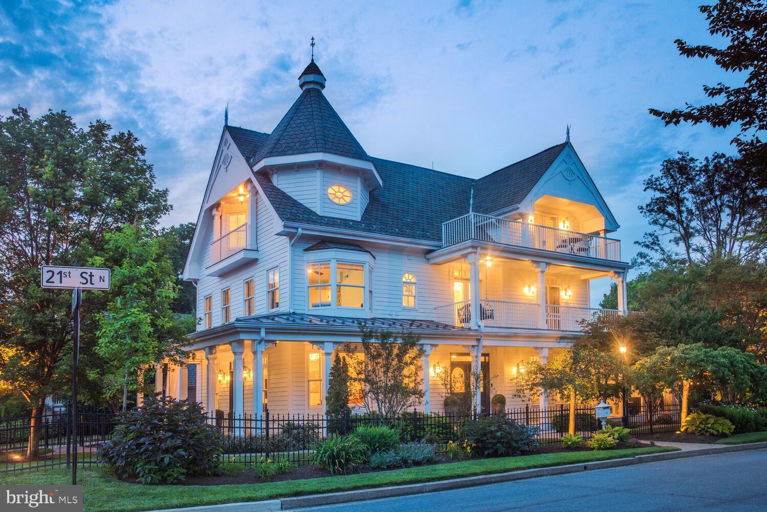 OPEN: THURS 6-7:30PM; SAT & SUN 1-3PM; Welcome to Stafford Hill- A modern Victorian masterpiece in the heart of Arlington's sought after Cherrydale neighborhood. Built in 2004 and completely reimagined and expanded in 2018, this storybook residence features 5400 impeccable interior square feet that include six bedrooms and five full baths spanning four, beautifully finished levels. Grand yet intimate, classic yet modern, an entertainer's dream that also feels like a private retreat- it is a marvel how one home can juxtapose so many qualities so perfectly in both its interior and exterior space. While this home embraces all of the elements, the one that unifies the entire space is glorious natural light. With 77 windows and doors, four skylights, two wraparound porches, an observation deck and two separate balconies this home was built with the natural beauty of its surroundings in mind. Moreover, Stafford Hill is sited on a gorgeously manicured 10,000 square foot corner lot that was designed by an award winning landscape architect and sits at one of the highest points in all of Arlington, affording the owners of this unique offering majestic views of the entire Washington DC skyline from National Airport to the Washington Monument to the National Cathedral. The interior of the home contains a playful, yet elegant mix of new and old world style. Six piece crown molding, gilded brass light fixtures and charming gas fireplaces blend seamlessly with 8" wide plank hardwood flooring, a crisp, contemporary paint scheme and every modern amenity one could dream of. Despite its size and grandeur, Stafford Hill remains magically intimate thanks to its perfectly proportioned division of space. The main level features an inviting entry foyer, a salon room with gas fireplace and grand piano, a separate dining room, a study, a living room with gas fireplace and a screened porch on the main level. The heart of the home lies in the gorgeously renovated, table-space kitchen off the salon with its Quartz counters & Carrera Marble backsplash, Virginia Soapstone Farmhouse sink, high-end appliances (Viking, Subzero, Bosch), Brizo Polished Chrome SmartTouch faucets, central island with a second hammered metal sink, built in bench seating and enormous walk in pantry. The first upper level contains three bedrooms and two full baths, including an expansive primary suite that opens to a wraparound porch and incredible observation deck that affords verdant views in Spring and Summer and Skyline & Monument views in Winter. The second upper level contains an additional two bedrooms- one built into the Victorian turret and another with an oversized picture window oriented above the observation deck to share its remarkable view, a gas stove and french doors leading out to a Widow's Walk balcony- as well as a full bathroom and separate loft-like living room. The lower level was masterfully redone as part of the 2018 renovation to provide an open and flexible family room that currently includes a theater room with a BenQ projector, built-in surround sound, blackout shades and a 110" screen adorned with retractable velvet theater curtains, a gym area, a large play area, a kitchenette, an additional bedroom, a renovated modern bath and an expansive storage room with additional washer/dryer hook up. A secret opening behind the floor to ceiling mirror leads to a hidden playroom under the stairs to add that touch of old world Victorian mystery and charm to this delightfully modern space. The list of thoughtful upgrades to this home is endless with many designed to aid in the comfort & performance of the home, including a three zone HVAC system, dual 75 gallon water heaters, additional soundproofing and full waterproofing in the lower level,  a separate washer/dryer hookup on the lower level, low voltage LED lighting on all interior staircases and an irrigation & custom exterior lighting system for the sensational lot. Check out the 3-D Tour!