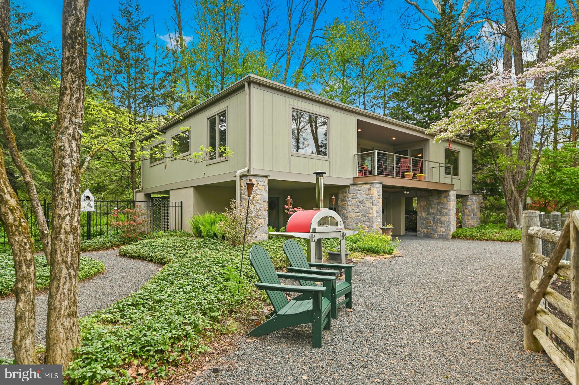Nestled down a private lane on a picturesque 1-acre riverfront setting, this exceptional property offers breathtaking views of the scenic Delaware River and direct river access for an unparalleled lifestyle. Thoughtfully designed with extraordinary attention to detail and quality craftsmanship throughout, every improvement has been meticulously executed by renowned custom builder Brett King.

Beautifully manicured grounds create a serene outdoor retreat, complete with access to the nearby towpath—perfect for walking, running, or biking along the river. The recently renovated exterior enhances the home’s timeless appeal, while inside, warm maple wood flooring flows throughout the living spaces.

The heart of the home is a stunning great room featuring a dramatic floor-to-ceiling stone fireplace with a wood-burning insert, creating both warmth and architectural impact. Custom built-ins add character and functionality, while expansive windows showcase spectacular river views from the great room, den/3rd bedroom, deck and primary bedroom. Step outside to the private back deck, where a secluded hot tub overlooks the tranquil landscape—an ideal setting for relaxation or entertaining.

Easy commute to Princeton, Philadelphia or New York to this incredibly peaceful retreat.

A rare offering combining privacy, craftsmanship, and an extraordinary riverfront location, this home is a true retreat with every detail carefully considered.