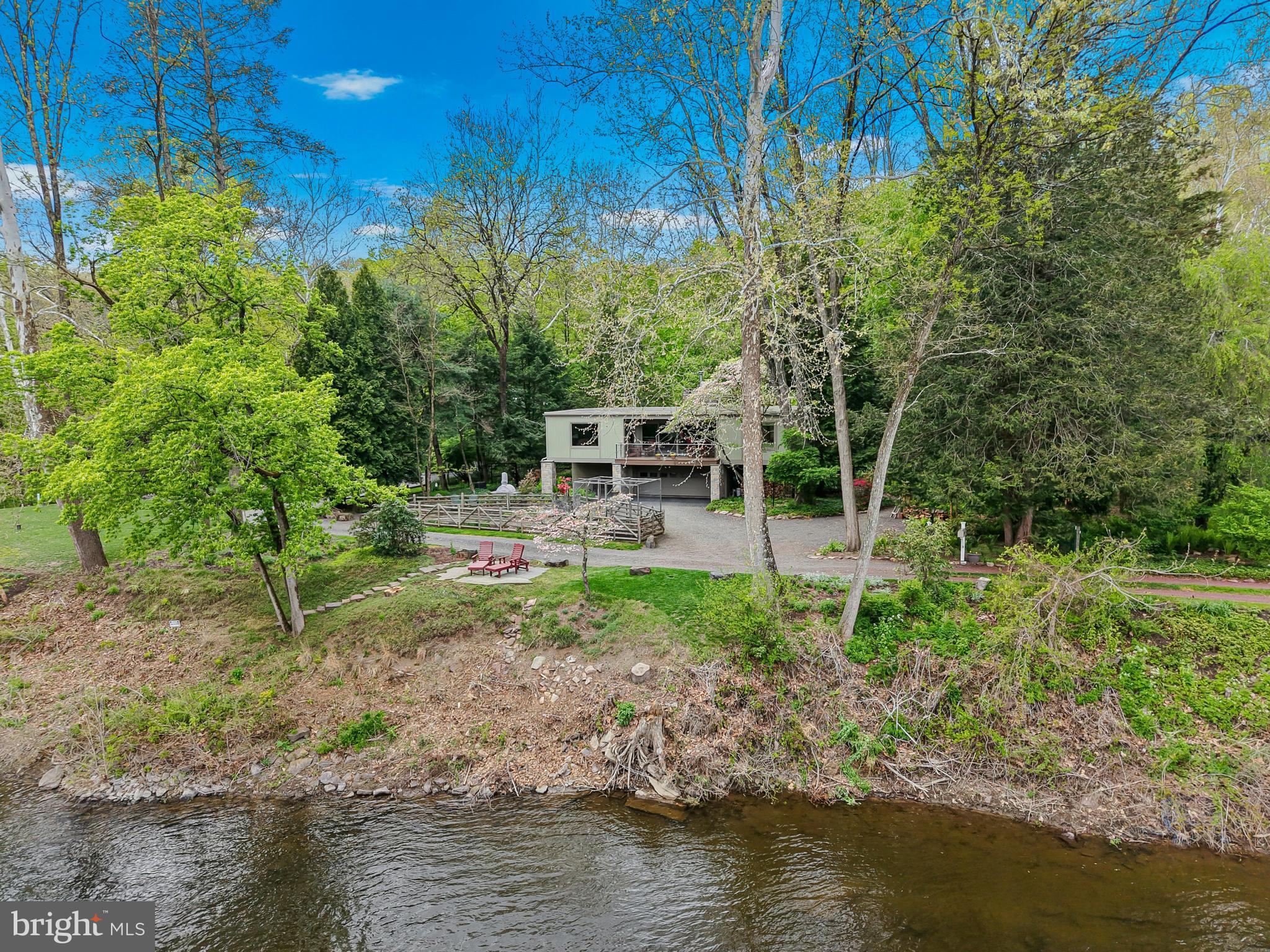 Private lane speed limit is 5 mph to insure safety. Please adhere

Nestled down a private lane on a picturesque 1-acre riverfront setting, this exceptional property offers breathtaking views of the scenic Delaware River and direct river access for an unparalleled lifestyle. Thoughtfully designed with extraordinary attention to detail and quality craftsmanship throughout, every improvement has been meticulously executed by renowned custom builder Brett King.

Beautifully manicured grounds create a serene outdoor retreat, complete with access to the nearby towpath—perfect for walking, running, or biking along the river. The recently renovated exterior enhances the home’s timeless appeal, while inside, warm maple wood flooring flows throughout the living spaces.

The heart of the home is a stunning great room featuring a dramatic floor-to-ceiling stone fireplace with a wood-burning insert, creating both warmth and architectural impact. Custom built-ins add character and functionality, while expansive windows showcase spectacular river views from the great room, den/3rd bedroom, deck and primary bedroom. Step outside to the private back deck, where a secluded hot tub overlooks the tranquil landscape—an ideal setting for relaxation or entertaining.

Easy commute to Princeton, Philadelphia or New York to this incredibly peaceful retreat.

A rare offering combining privacy, craftsmanship, and an extraordinary riverfront location, this home is a true retreat with every detail carefully considered.