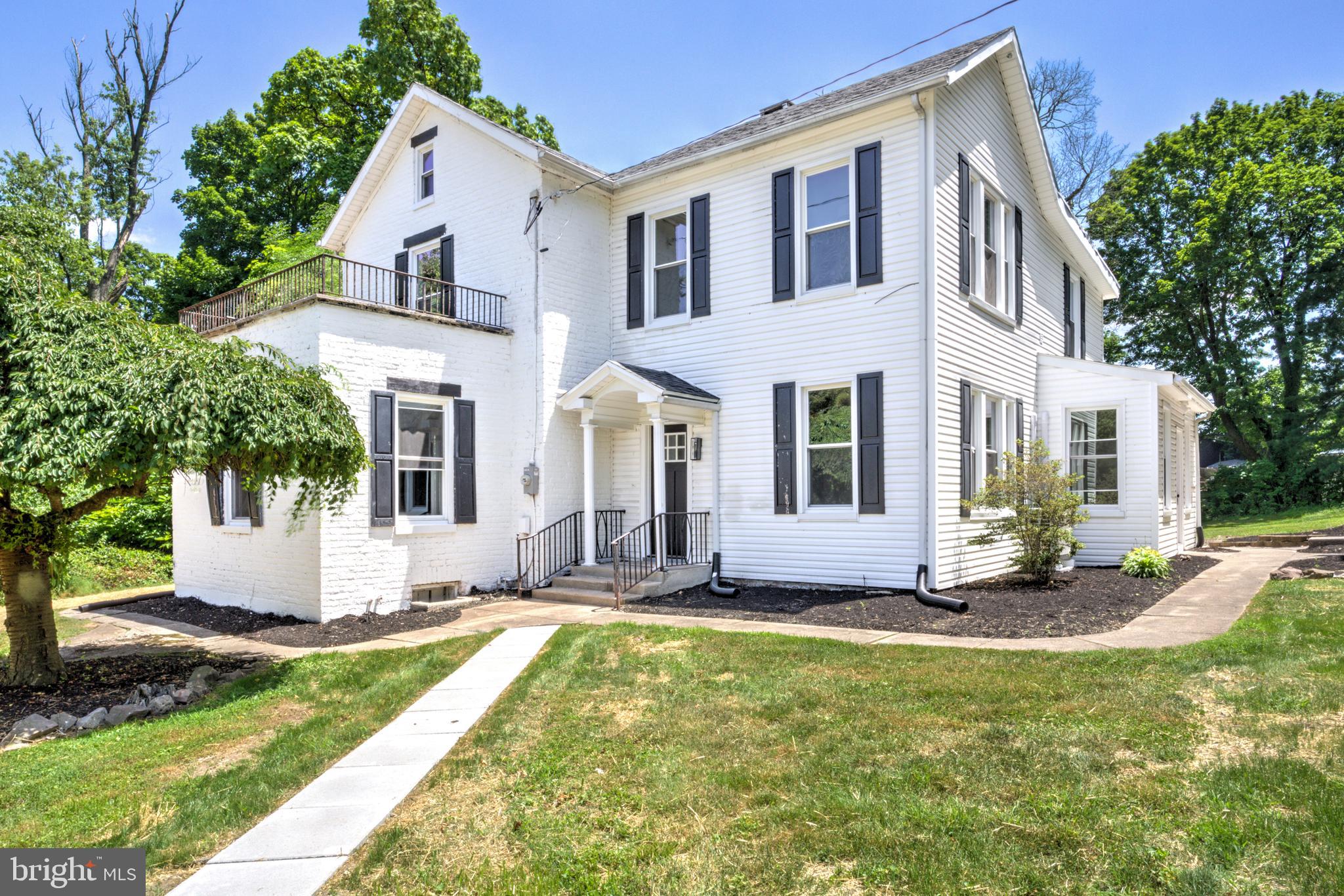 Welcome to this beautifully renovated and restored turn-of-the-century home on about an acre of lush, usable land just minutes from the Susquehanna River! This stately brick residence showcases timeless curb appeal with traditional shutters, an elegant covered front porch, original wood double entry doors, and abundant historic character throughout. A brand-new detached garage provides protected parking, storage, and hobby space. Inside, you'll find an impressive blend of preserved craftsmanship and modern updates! The original wood staircase sets the tone, while large, sun-filled formal rooms feature refinished hardwood floors, flexible living spaces, two fireplaces, and beautiful original millwork and paneling. The stunning new kitchen complements the home's character with natural wood-stained cabinetry, classic subway tile, quartz countertops, stainless steel appliances, and a large center island ideal for prep, dining, and gathering. A convenient first-floor powder room adds everyday functionality. Upstairs, the second floor offers three spacious bedrooms with high ceilings, oversized windows, and more refinished hardwood flooring. The luxurious primary suite features a generous bedroom with fireplace, dual closets, and a brand-new oversized ensuite bath with a double vanity, soaking tub, and tiled walk-in shower. A second full bathroom includes a tiled tub/shower combination, while second-floor laundry adds convenience. Additional upgrades include brand-new windows throughout and a new multi-zone HVAC system for year-round comfort and efficiency. Rarely does a home offer this level of character and modern convenience. Don't miss your opportunity to own a truly special property!