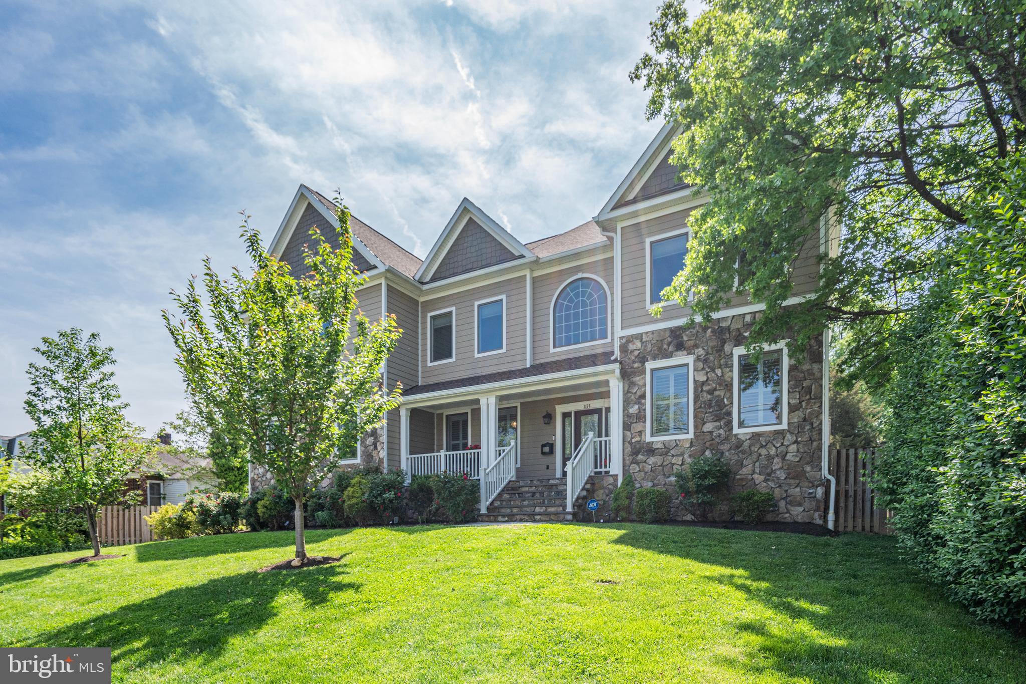 This home is *Spectacular* providing an abundance of space with large rooms and comfortable living on every level and exquisite finishes throughout. First, step outside to the beautiful backyard, a wonderful 1/2-acre lot, wide and deep and fully fenced - almost unheard of in N. Arlington - for endless enjoyment and entertainment for all.   This wonderful green space will bring you so much satisfaction, relaxation and Fun!  Front porch is perfect for morning coffee. Inside, the two-story foyer and winding wooden staircase welcome you in with the dining room on the left and elegant living room on the right.  Walk through to the gourmet kitchen which is open to the family room with 20' ceiling and fireplace.  This kitchen is a chef's dream with stainless steel appliances, gas cooktop, an enormous island for sitting, a separate breakfast space for a table, a large pantry and ample cabinetry for all of your necessities.  You will enjoy cooking and entertaining in this home.  The kitchen and family room open up to the deck in the rear overlooking fabulous flat and fenced yard. Again, a true gem in N. Arlington.  Convenient mudroom adjacent to kitchen and just off the garage for unloading and powder room for easy access. There are 6 bedrooms and 5.5 Baths with a large main level bedroom suite &  lower-level bedroom suite. Every room is substantial.  The upper level is stunning with a gorgeous primary suite, two walk in closets, enormous bathroom with soaking tub , separate shower, double vanities and additional closet space.  There are 3 additional bedrooms on the upper level with connected bathrooms, two share a gorgeous Jack and Jill and the other is an independent suite. Also, ideally located on the upper level is the laundry room, doing the laundry is easy.  Finally, enoy the generously sized lower level with recreation room, games area, bar with seating, dishwasher, wine fridge, and cabinets. There is also a large lower bedroom suite.  This home is conveniently located for Ballston Metro,  Westover's shops and restaurants and the popular Pupatella Pizza.  There is plenty of storage for all your extras. Do not miss this wonderful spacious, comfortable home and fabulous backyard for fantastic living. Looking for your needle in the haystack. Here it is. Welcome Home!