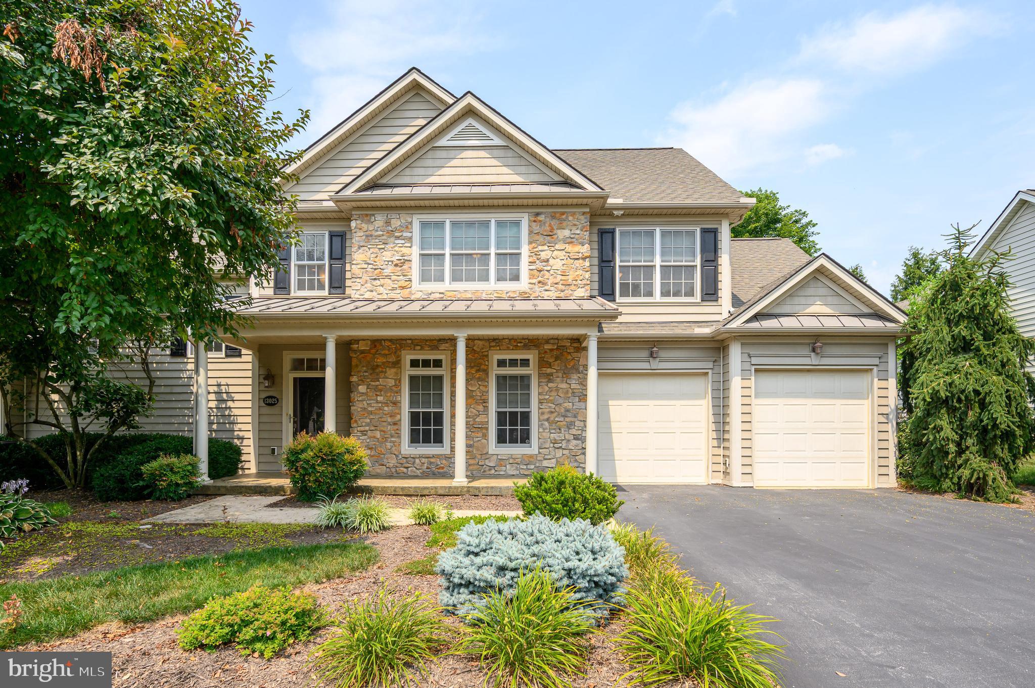 Welcome to 13025 Hawkins Circle, a beautifully appointed villa in the highly desirable Cortland Villas community. Offering 4 bedrooms, 3 full bathrooms, and more than 2,800 square feet of thoughtfully designed living space, this home blends quality craftsmanship, timeless elegance, and everyday comfort, all just minutes from shopping, dining, and major commuter routes! From the moment you arrive, you'll appreciate the inviting covered front porch, stone accents, mature landscaping, and attached two-car garage with a spacious driveway. Inside, the light-filled open floor plan is designed for both effortless entertaining and comfortable everyday living. The dramatic two-story living room features hardwood flooring and a striking two-sided gas fireplace that opens to a bright and inviting sunroom where you'll find yourself enjoying your morning coffee or unwinding at the end of the day. From the sunroom, step outside to the rear concrete patio, perfect for relaxing or hosting family and friends. The gourmet kitchen is sure to impress with granite countertops, stainless steel appliances, touchless sink faucet, cooktop (with rough-in for gas option), double oven, under-cabinet lighting, a large center island, and abundant cabinetry. Just off the kitchen, the formal dining room provides the perfect setting for gatherings while keeping everyone connected. The spacious main-level primary suite offers hardwood flooring, a tray ceiling, a walk-in closet with washer/dryer, and an ensuite bath featuring an updated custom tiled shower with a rain shower head, double vanity, heated towel rack, and a jetted soaking tub. A second main-level bedroom includes hardwood flooring, a walk-in closet, and easy access to a full bath, perfect for guests or a den. Upstairs, you'll find two generously sized bedrooms, another full bathroom, and a versatile bonus room that can easily serve as a fifth bedroom, media room, playroom, or home gym. Additional highlights include two HVAC systems with smart thermostats for ultimate comfort and built-in surround sound speakers throughout the home. Enjoy the ease of low-maintenance living in Cortland Villas while being close to everything you need!