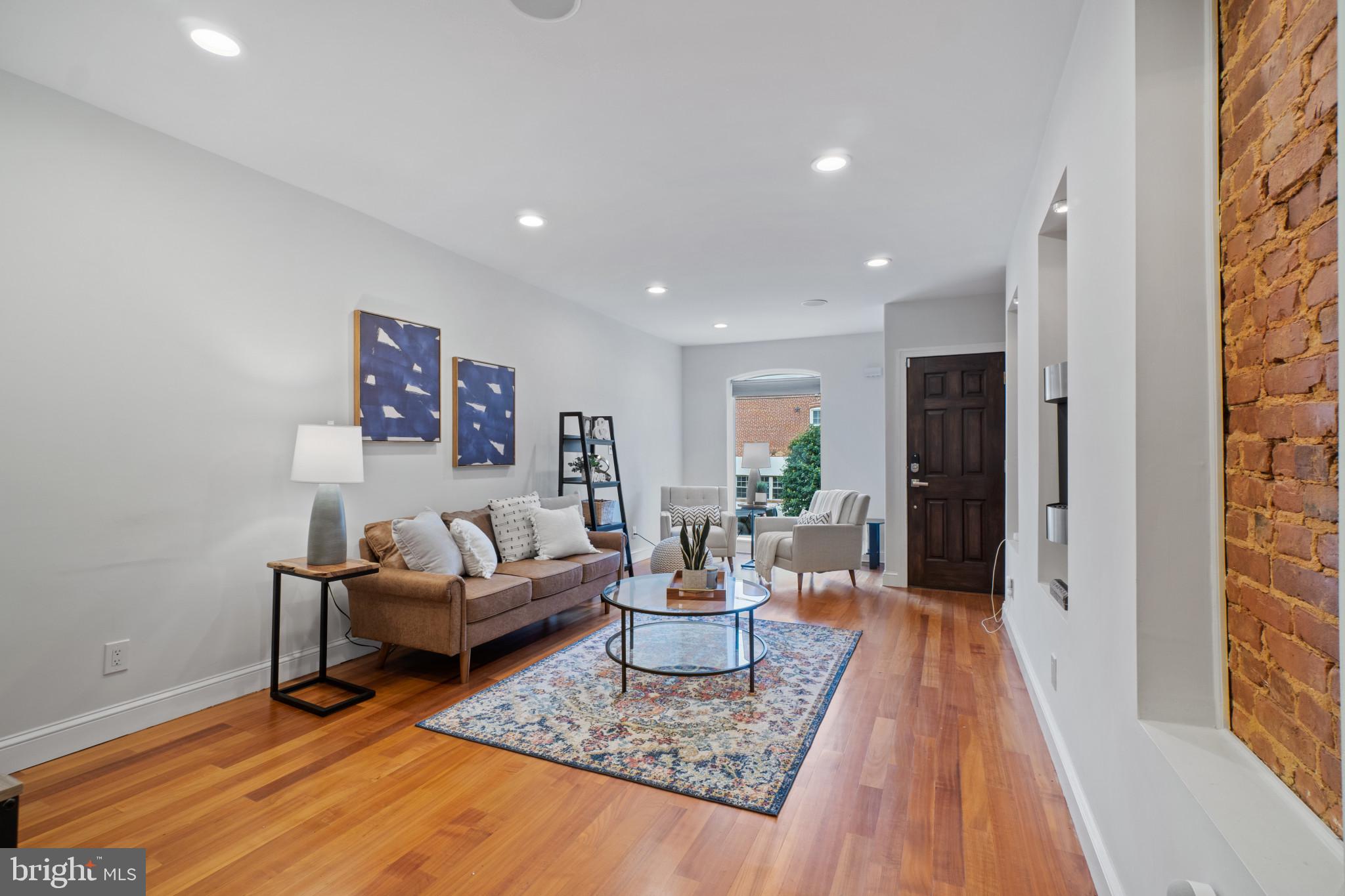 Welcome to 1404 Jackson Street, a stunning 3 bedroom, 3.5 bathroom rowhome located in the heart of South Baltimore. This gorgeous home boasts over 2000 sqft of living space with tasteful upgrades and stylish finishes throughout. As you enter the home, you are greeted by a spacious and light-filled living area. The custom steel and concrete staircase is a true showstopper and adds a modern touch to the home's aesthetic. The kitchen is a chef's dream, featuring professional-grade stainless steel appliances and sleek concrete countertops. The second floor boasts a large primary bedroom suite and an additional bedroom and full bath. As you make your way up to the third floor, you will be greeted by a beautifully designed wet bar that features an under-counter beverage center, perfect for entertaining. But that's not all - as you step outside onto the rooftop deck, you'll be captivated by the breathtaking water and city views that stretch out before you. Whether you're enjoying a morning cup of coffee or hosting a summer barbecue, this rooftop oasis is sure to impress. And if you're in need of additional space, this home has you covered. A third bedroom/den with an adjoining full bath offers flexibility and versatility, allowing you to customize the space to suit your needs. Parking is a breeze with the covered parking pad located in the rear of the home. Don't miss your chance to make it yours today!