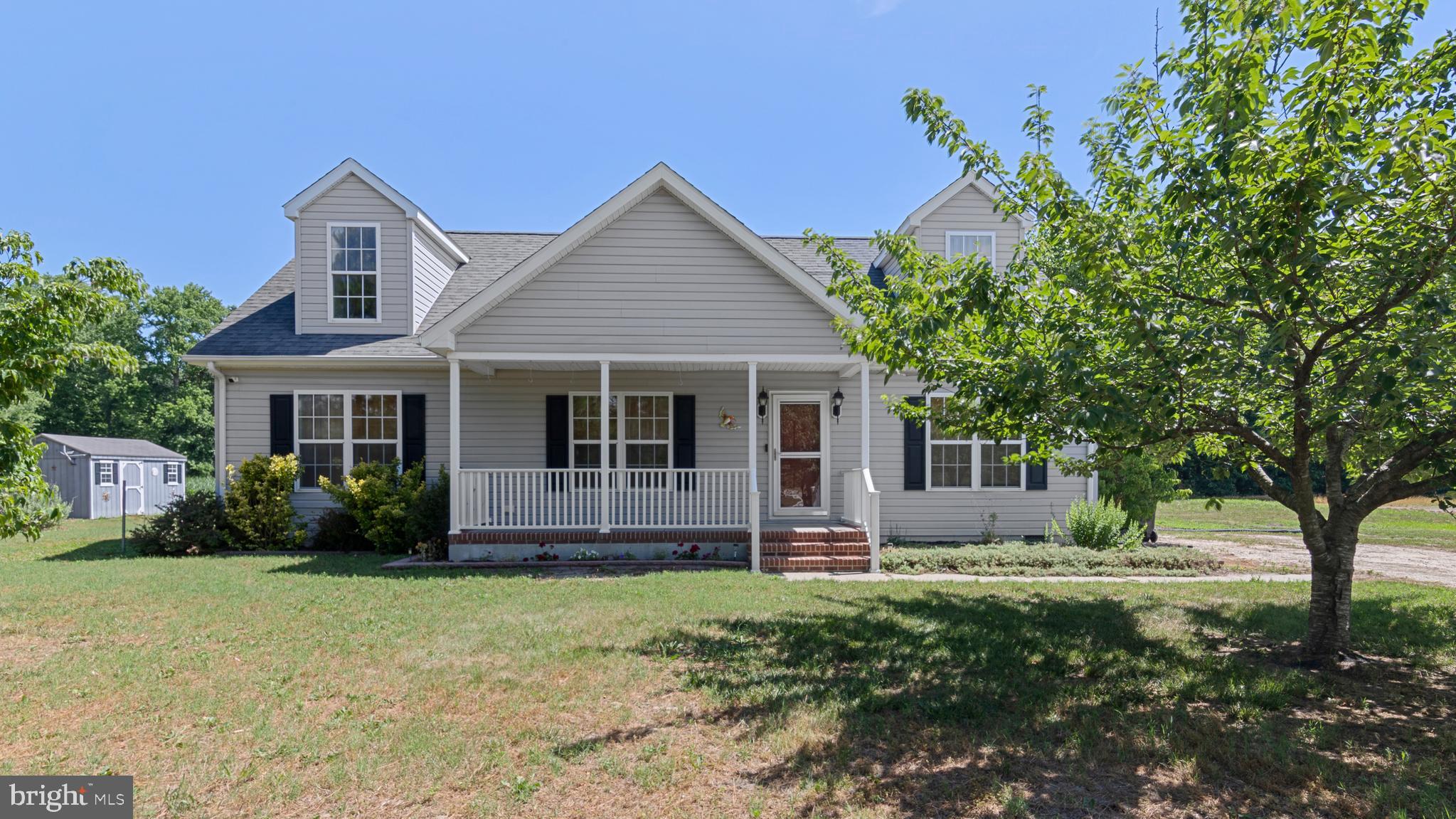 Situated on 10.2+/- acres with wide-open farm views, this 4-bedroom, 3-bath Cape Cod offers a practical layout and plenty of space to enjoy country living. The main level features a primary suite, an additional bedroom, and a kitchen with stainless steel appliances that opens to the living room. Hardwood floors run throughout the main living areas. Upstairs, you'll find a lounge area, two well-sized bedrooms, and a full bath. Outside, the patio overlooks the surrounding farmland, and a shed provides additional storage. With open acreage and room for a variety of agricultural, recreational, or hobby farm uses, this property offers flexibility in a peaceful rural setting.
