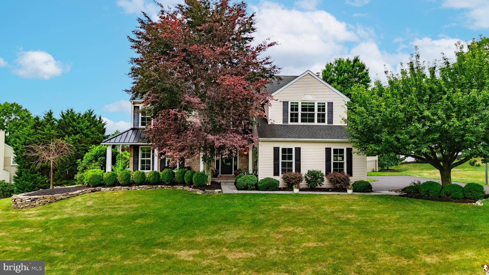Welcome to 24 Brinker Drive N, an exceptional residence in the highly sought-after Doylestown Knoll community where timeless design, quality craftsmanship, and resort-style outdoor living come together beautifully. From the moment you arrive, you’ll appreciate the home’s outstanding curb appeal, mature professional landscaping, and inviting covered front porch. Inside, gleaming hardwood floors flow throughout the main level, leading to a thoughtfully designed floor plan perfect for both everyday living and entertaining. The beautifully renovated chef’s kitchen showcases custom Village cabinetry, premium appliances, generous workspace, and opens seamlessly to the welcoming family room anchored by a cozy gas fireplace. A sun-filled four-season room overlooks your own private backyard retreat featuring extensive custom hardscaping, multiple patios, landscape lighting, and a stunning Carlton in-ground pool surrounded by meticulously maintained gardens. Upstairs, the spacious primary suite offers a spa-inspired bath with a cast iron soaking tub, oversized walk-in closets, and quality finishes, while three additional generously sized bedrooms share an updated hall bathroom. The finished lower level provides exceptional flexibility with expansive recreation space, a dedicated home office and/or fitness area, and abundant storage. Replacement windows, a newer front entry door, and numerous thoughtful updates throughout reflect the exceptional pride of ownership found in every corner of this home. Ideally located just minutes from the award-winning shops, restaurants, parks, museums, and year-round events of historic downtown Doylestown, with convenient access to major commuter routes, regional rail service, and highly acclaimed Central Bucks schools, this is a rare opportunity to own one of Doylestown Knoll’s finest homes—where luxury, comfort, and everyday functionality come together to create an exceptional lifestyle. Some photos have been virtually enhanced and staged to show potential layouts and views. Open House Saturday, 7/11, from 12PM to 2PM. Cameras on premises, please be aware.
