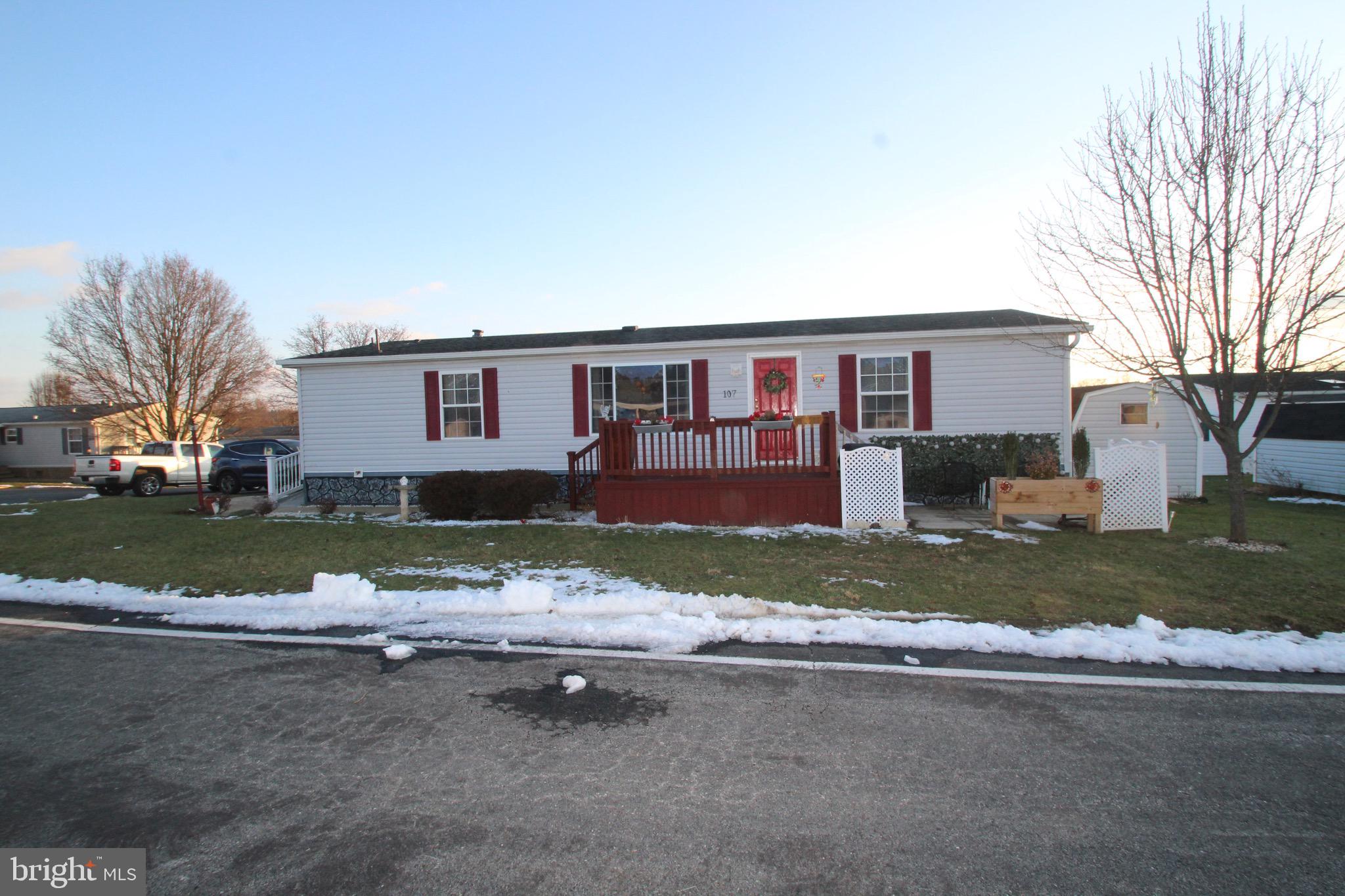 Lovely upgraded home in the attractive and convenient community of Pheasant Ridge. Community pool, gym, playground, basketball courts  are a plus and included in the lot rent plus cable and trash are included. Ramps added for easy access and a 2 level deck for enjoying the good weather.  hardwood floors LR, DR, Kitchen. handicap owners bath added. A lovely built in kitchen seating area and All appliances stay, the painted kitchen cabinetry is on point with current trends and a beautiful tile backsplash completes the look. The wood burning fireplace offers warmth and charm. A new gas furnace and central air were added in 2021. 
Just move right in and unpack your boxes…everything is done for you! This one is worth a look.