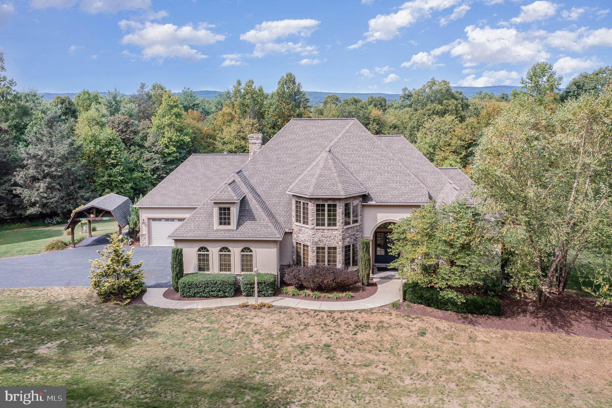 Welcome to your dream retreat nestled in a serene rural setting! This stunning traditional-style home, built in 2010, offers a perfect blend of modern comfort and timeless elegance. With 4 spacious bedrooms and 4.5 
bathrooms, this residence is designed for both relaxation and entertaining. As you approach the property, you'll be captivated by the charming exterior, featuring a combination of durable Dryvit and stone materials that enhance its curb appeal. The expansive 45.32-acre lot provides ample space for outdoor activities and showcases breathtaking views of lush trees and scenic vistas, creating a tranquil backdrop for your everyday life. Step inside to discover a warm and inviting atmosphere, highlighted by a cozy fireplace that serves as the heart of the home. The well-appointed kitchen and open living spaces are perfect for gatherings, while the attached oversized garage with space for up to five vehicles ensures convenience and ample storage. The primary bedroom boasts of a second fireplace and the perfect balance of luxury and functionality. Outside, indulge in your own personal oasis with your private spa and pool, ideal for summer relaxation and entertaining guests. The property also features outbuildings, offering additional storage or potential for creative use. This exceptional home is not just a residence; it's a lifestyle. Embrace the peace and privacy of rural living while still being within reach of local amenities. Don’t miss the opportunity to own this remarkable property that perfectly balances comfort, style, and nature. Schedule your private tour today and experience the beauty and tranquility for yourself!