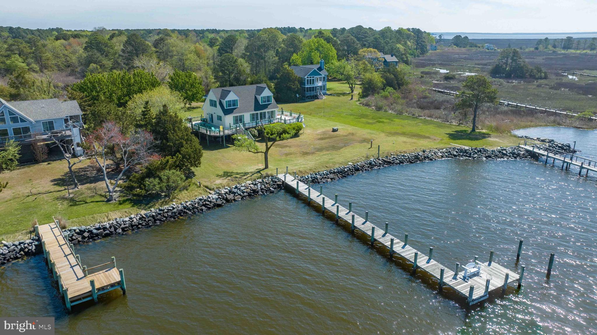 Please check out the Fly-Through Video! Perfectly isted on 3.64 Acres, this charming cape cod style home offers 3 bedrooms, 2.5 baths and the most incredible water views as far as the eyes can see. To the South, you can see Dames Quarters and Chance, MD in Somerset County. Southwest is Bloodsworth Island and West (directly across) is Elliotts Island. Truly one of the best locations on The Eastern Shore to view the most breathtaking sunsets. You can see the water from every room in the home (except the full bathrooms!). The 1st level features the Owner's Suite with its own private and fully remodeled bathroom. Also on the 1st level is the Family Room and adjacent to the Family Room is the Kitchen. Kitchen highlights include beautiful granite countertops, new sink and new flooring. Just past the Kitchen is the formal living room which could also serve as the dining room; you decide the use of this space. Upstairs is a full bathroom, flanked by 2 spacious bedrooms. Exterior Highlights: approx. 100' pier, 150' shoreline, an oversized wrap-around deck and 2 storage sheds. Recent updates include a new architectural shingle roof (approx. 2 1/2 Years).
