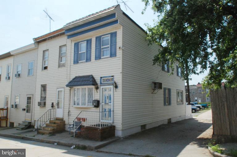 End unit townhome. Large bath and laundry room on the upper level. Large kitchen in the rear of the home leads to rear porch and fenced yard. Full unfinished basement. There is a large lot (30x90) behind this home that allows parking for up to 5 cars. This lot has a separate tax id# but is included in the sale.  Boiler, hot water heater and window air units have all been replaced.