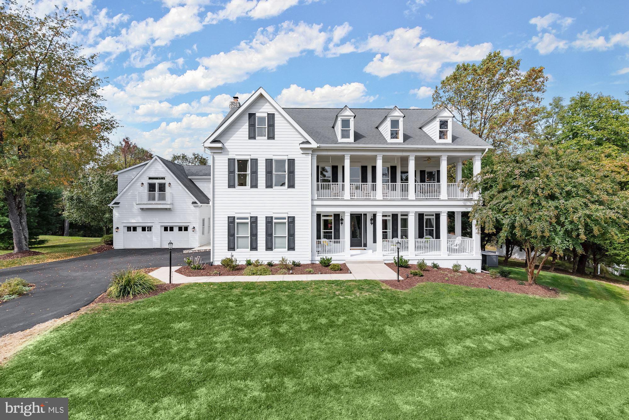 UNPARALLELED DESIGN, BEAUTY, AND RECREATIONAL OPPORTUNITIES This recreational paradise provides unlimited outdoor living to complement an unforgettable home interior boasting luxury amenities at every turn. With a nod to traditional Southern architecture, this property was completely redesigned and rebuilt in 2009 with stately columns, shuttered windows, balconies, and expansive porches that bring the outside in. Tempting views provide glimpses of the resort-styled exterior features that encircle the glistening in-ground pool which include a large, detached pool house with oversized sliders, a kitchenette, a half bath, and a cozy gas fireplace to extend fun throughout the seasons. Overlooking the pool is an attached deck and built-in dining adjacent to a pavilion and bar. The central pool, sun deck, dining deck, and bar transition seamlessly to the more adventurous activities that include a pickleball/ basketball sport court, and volleyball, all fringed with landscaping and mature trees that add privacy. Inside, the rebuilt, designer interiors are thoroughly upgraded and modern, with an open-plan layout and pristine ebony hardwood flooring throughout the main level and upper halls. In the open-plan kitchen and dining area, a palette of crisp white cabinets and white Carrera marble embellish the central entertainer’s island crowned with a large pendant appropriately scaled for the space. Professional stainless-steel appliances surround the island and breakfast bar, while a secondary peninsula island, coffee bar, prep sink, separate wine bar, and generous walk-in pantry stand at the ready to provide for every cook's need. A cozy sitting space and commanding gas fireplace remember the Southern Keeping Room concept, located opposite the coffee bar and is perfect for morning coffee or evening wine. The central cook’s kitchen invites gatherings, large and small, offering a banquet-sized breakfast room, sunroom, and adjacent receiving room/dining area sided by a light-filled family room with a gas fireplace and coffered ceiling. Downstairs, a walk-up lower level is outfitted with a theater room that is currently being used as a bedroom, a finished custom walk-in closet, and an elevator that services all three levels. Take the open winding stairs or a short elevator ride to the upper-level bedrooms and porches. Luxury amenities continue into the opulent primary bedroom suite, outfitted with a separate sitting room and wet bar with sink, fridge, and dishwasher drawer. The bedroom suite advances into a light-filled, resort-like bathroom clad in white wrap-around vanity cabinetry, white marble tops, and mirrors reflecting a sparkling chandelier. A private balcony streams light through the glass doors, and an adjacent walk-in closet with built-in wardrobe organizers complete the sumptuous primary bedroom suite. The upper level also hosts a separate laundry room, work-at-home office/homework space, and four more bedrooms including the bonus bunk room that features six bunks and a balcony deck overlooking the pool. There is no detail left out of this rebuilt luxury residence inside or outside. There are endless amenities including access to porches or balconies from every bedroom, rich wood floors, strong architectural moldings, designer lighting, an open floor plan for gathering, and an elevator. Outside, a circular drive, low maintenance HardiPlank, composite decks, separate attached garages with four bays, a secondary entry, and breezeway to pool, pool house, decks, and sports court. Updates in 2023 include: HVAC system for the pool house, pool pump, 400,000 BTU pool heater will convey (not installed), replaced components for the well system, HVAC compressors for the main level and primary bedroom, replaced refrigerator in the primary bedroom wet bar, water heater for the main house, and dishwasher in the kitchen. Come home and enjoy perfected luxury living with unparalleled quality, design, beauty, and recreational opportunities!