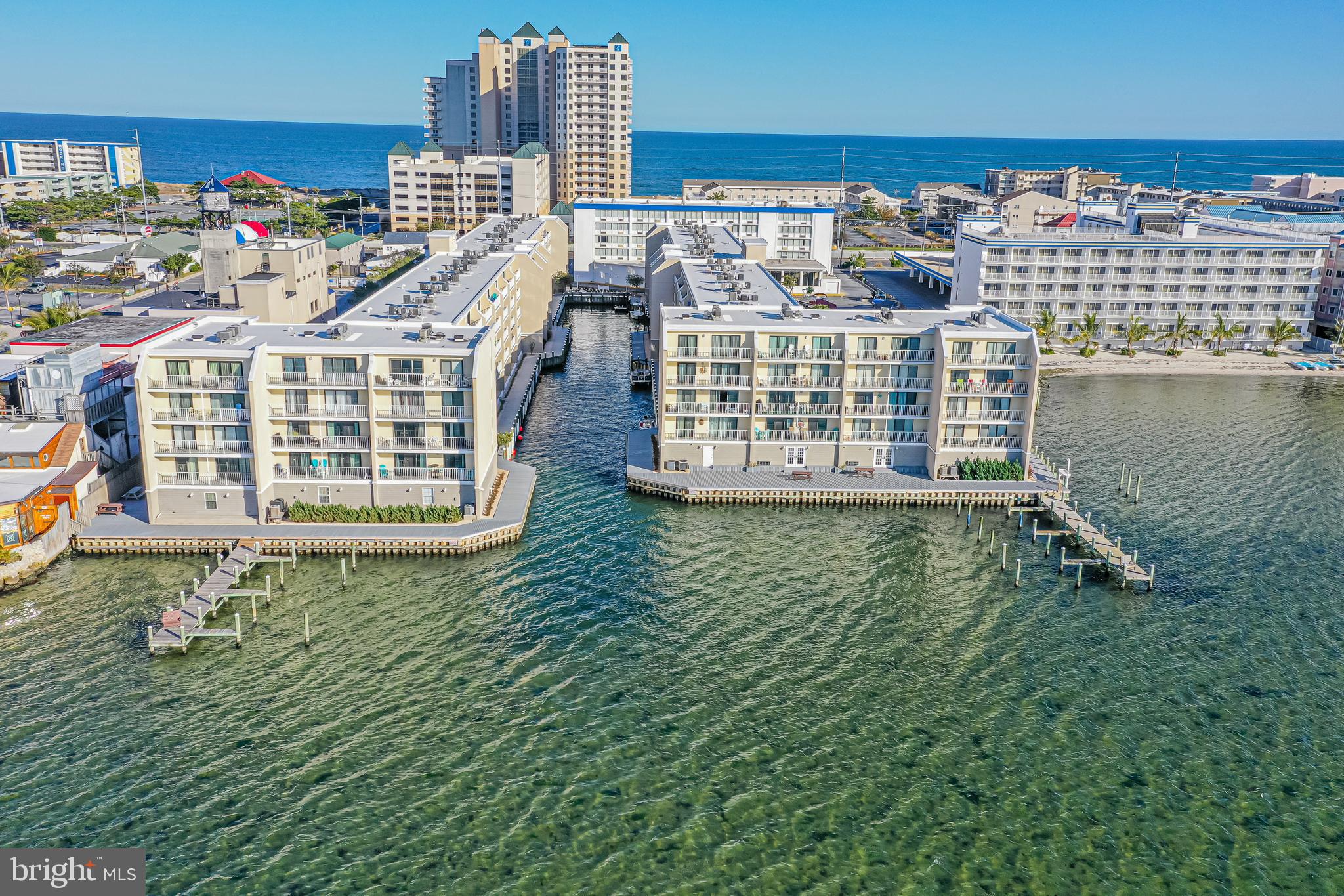 BEAUTIFUL BAYSIDE WATERFRONT LIVING!!! This 2BR, 2BA  Penthouse-Level Unit has been delightfully designed and decorated! This unit boasts an oversized balcony with access from the living room and the primary bedroom. New HVAC, New Luxury Vinyl Plank Flooring Throughout, New Base Trim Throughout. WiFi Doorknob, WiFi Thermostat.  Newer Building Roof, New Bulkhead and Walkway. Condo Association has been great about maintenance! Completely turnkey with tasteful furnishings. All furniture, TV's, Wall Décor, Kitchen Items Convey and Balcony furniture conveys. Bedroom furnishings include a Queen-size bed and a King-size bed. Living room has a Queen-size sleep sofa. Located in the heart of Midtown. Close to the Beach!! All Beach Items Convey. Close to restaurants, shopping and activities! Boat and Jet Ski slips are available to rent on a first come first serve basis. Storage available for rent, also on a first come first serve basis. On-site laundry. Bayfront outdoor pool. Reserve study has been completed and there has been a $5,000.00 special assessment as a result. This assessment has already been paid in full by the Seller.  Great rental income!