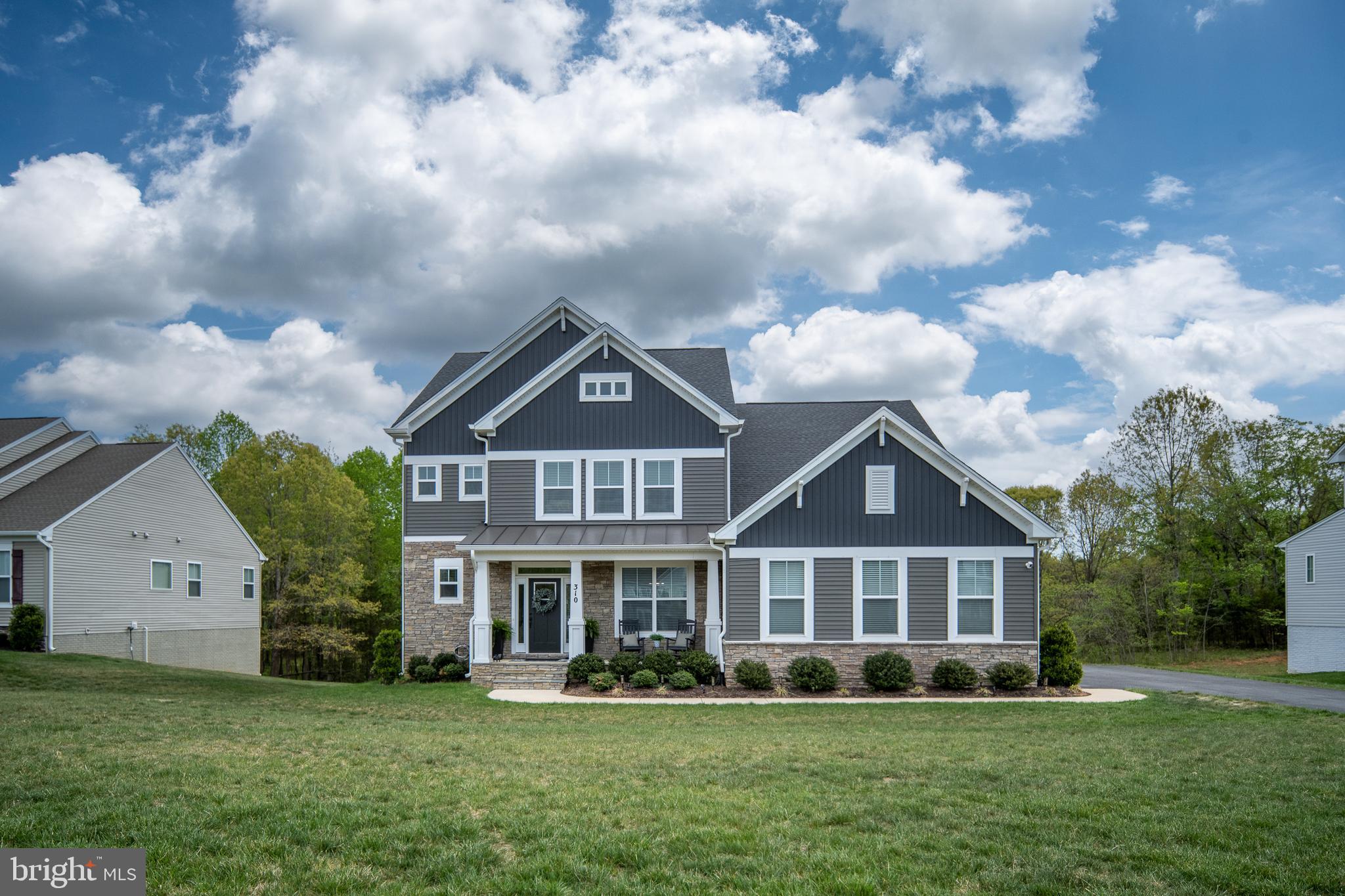 Welcome Home to a Rare Blend of Space, Style, and Convenience. Imagine pulling into your driveway, leaving the hustle of the day behind, and arriving at a stunning stone-front estate nestled on 1.5 acres of private, lush land. Built in 2022 by the renowned Atlantic Builders, this home in the highly sought-after Liberty Hall community isn’t just a place to live, it’s the lifestyle upgrade you’ve been searching for.

From the moment you step inside, you are greeted by soaring 9' ceilings and a light-filled floor plan designed for the way we live today. The show-stopping gourmet kitchen is truly a chef’s paradise. With dual custom quartz islands, soft-close cabinetry, and a spacious walk-in pantry, it provides the perfect backdrop for morning coffee or hosting holiday gatherings. Need to tackle some emails? The dedicated pocket office offers a sleek, functional workspace without sacrificing your main living areas.

Why go on vacation when your backyard is a private retreat? Entertainers will fall in love with the expansive composite deck, featuring a custom bar top, grill bump-out, and ambient lighting. As the sun sets, retreat to the walkout basement to enjoy your 2023 Hot Springs Grandee saltwater hot tub, the ultimate spot to unwind under the stars.

Upstairs, the primary suite serves as your private sanctuary, boasting two expansive walk-in closets and a spa-inspired bath with dual quartz vanities and a massive walk-in shower. Flexibility is key here: one secondary bedroom features a private en-suite bath, while the remaining bedrooms share a well-appointed Jack-and-Jill bathroom.

The finished walkout basement expands your living space even further, offering a bedroom, full bath, and a versatile bonus room ready to become your home gym, guest suite, or creative studio.

This is more than just a home; it’s a move-in ready, modern masterpiece that offers the acreage and privacy you want, with the location you need. If you’ve been waiting for a home that checks every box, modern construction, luxury upgrades, and the space to truly spread out, your search ends here.