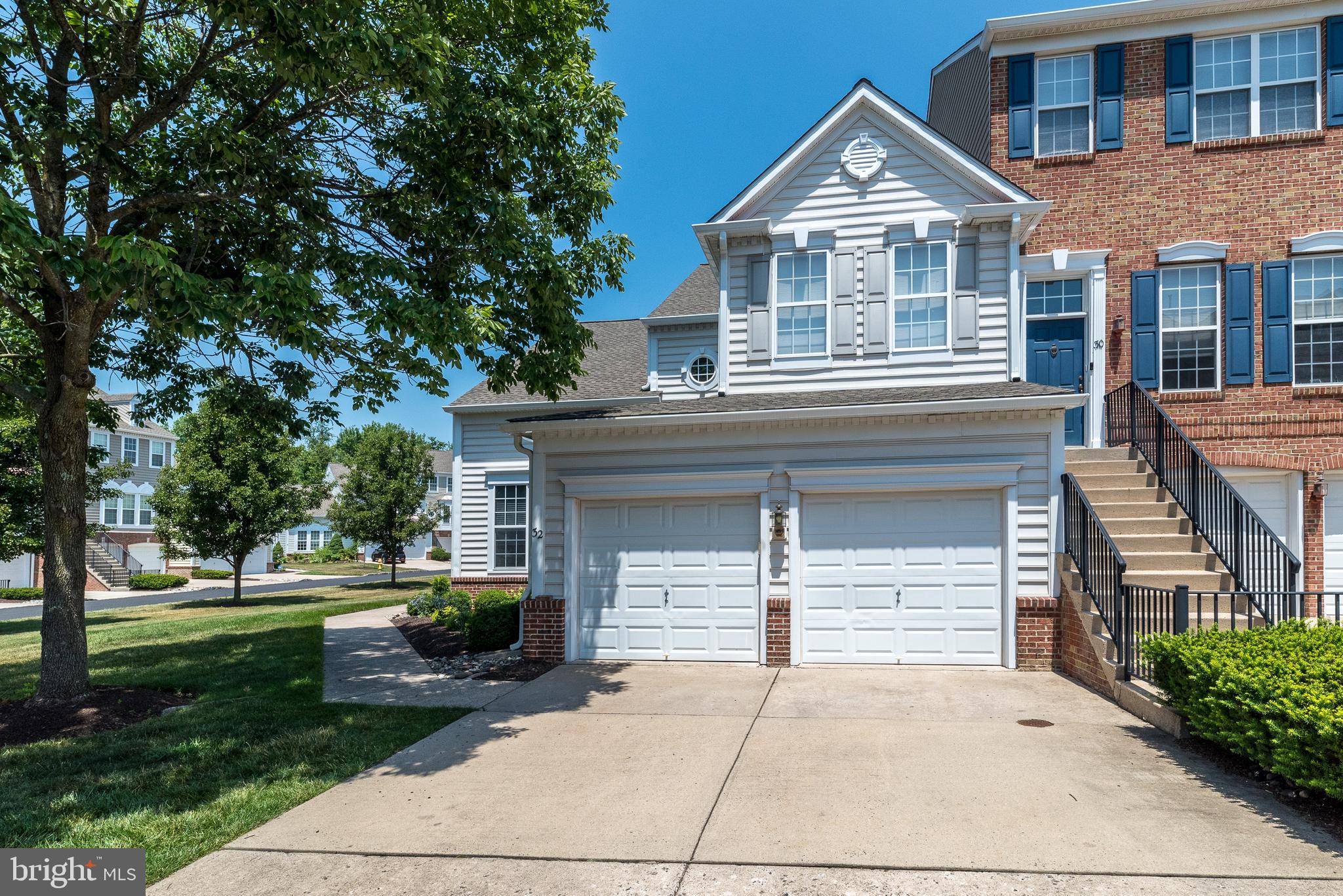 Experience effortless luxury living in this highly sought-after Deerfield model end-unit in desirable Doylestown Station which is tucked away in the back part of the neighborhood. Proudly featuring the convenience of a first-floor primary suite and an exceptional open floor plan designed for today's lifestyle. A welcoming foyer with gleaming hardwood floors leads into the spacious living and dining areas, where abundant natural light, soft neutral tones, and oversized windows create a warm and inviting atmosphere. The dramatic family room boasts a soaring volume ceiling, a gas fireplace with a beautiful architectural mantel, and brand new carpeting which offers sliding doors opening to a generous Trex deck, beautifully shaded and offering privacy, a perfect spot for relaxing or entertaining. The gourmet kitchen is beautifully appointed with quartz countertops, a neutral stone tile backsplash, upgraded cherry cabinetry, stainless steel appliances, double ovens, gas cooking, a pantry, and a breakfast bar for casual dining. The first-floor primary suite offers comfort and convenience with a spacious bedroom, walk-in closet, additional closet, and a luxurious ensuite bath featuring a soaking tub, separate shower, double vanity, and linen closet. A powder room, laundry room, and direct access to the attached two-car garage complete the main level. Upstairs, you'll find an impressive 27' x 24' loft, ideal as a second family room, home office, or media space, along with two generously sized bedrooms connected by a Jack-and-Jill bathroom.The finished basement provides even more living space, offering a large recreation room, exercise room or home office, and a full bathroom for guests. Also features tons of closet space, a large workshop area, and huge storage area. Enjoy a truly low-maintenance lifestyle with exterior maintenance handled by the association, giving you more time to take advantage of everything this outstanding location has to offer. Just steps away is Doylestown's beautiful Central Park, featuring scenic walking trails, sports fields, playgrounds, and summer concerts. You'll also appreciate the home's close proximity to the vibrant Borough of Doylestown with its charming shops, restaurants, museums, and year-round community events. This exceptional home combines luxury, space, convenience, and one of the area's most desirable locations and walking distance to Kutz Elementary School, this is an opportunity not to be missed.