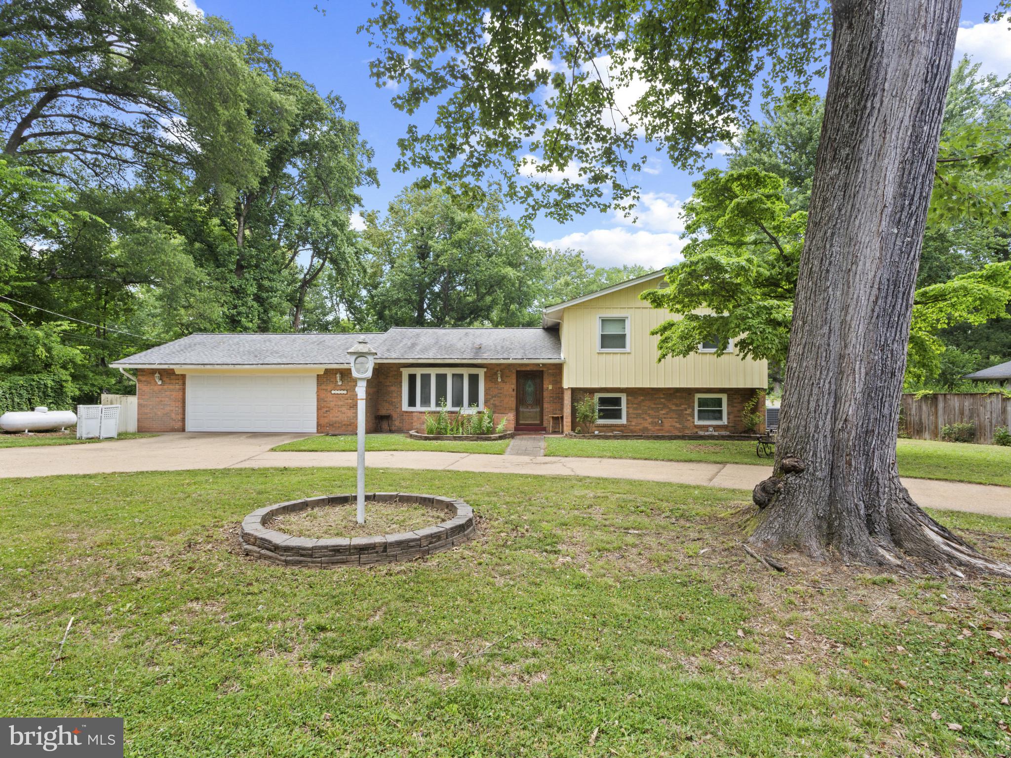 Charming single-family residence offering 3 bedrooms, 2 full bathrooms, 2,382 finished square feet, and an oversized 2-car garage in desirable waterfront Calvert Manor. Ideally situated on a spacious homesite with seasonal views of Piscataway Bay, this property combines comfortable indoor living with exceptional outdoor amenities and access to the surrounding natural beauty. // A private circular driveway creates a welcoming arrival and enhances the home's curb appeal. Inside, hardwood flooring flows throughout the main level, where a bright and inviting living room is highlighted by a large bow window that fills the space with natural light. The dining room provides an ideal setting for everyday meals and special gatherings alike. The kitchen is thoughtfully appointed with stainless steel appliances, granite countertops, a pantry, and convenient exterior access, making outdoor entertaining effortless. // Three well-proportioned bedrooms offer comfortable accommodations, including the primary bedroom, complemented by a full bathroom thoughtfully positioned for everyday convenience. // The spacious lower level expands the home's living space with a cozy family room featuring a fireplace insert and walkout access to the backyard. This level also includes a second full bathroom, a dedicated laundry room, and a versatile bonus room that can easily serve as a recreation room, home office, fitness area, or guest space. A large storage room provides ample space for seasonal items and household essentials. // Outdoor living is designed for relaxation and enjoyment, featuring a patio overlooking the backyard and an in-ground pool, creating a private retreat for summer entertaining and everyday enjoyment. // Residents of Calvert Manor can enjoy access to nearby Calvert Manor Park, which offers a private pavilion, dock, and water access, providing opportunities for boating, fishing, kayaking, and taking advantage of the area's scenic waterfront setting.