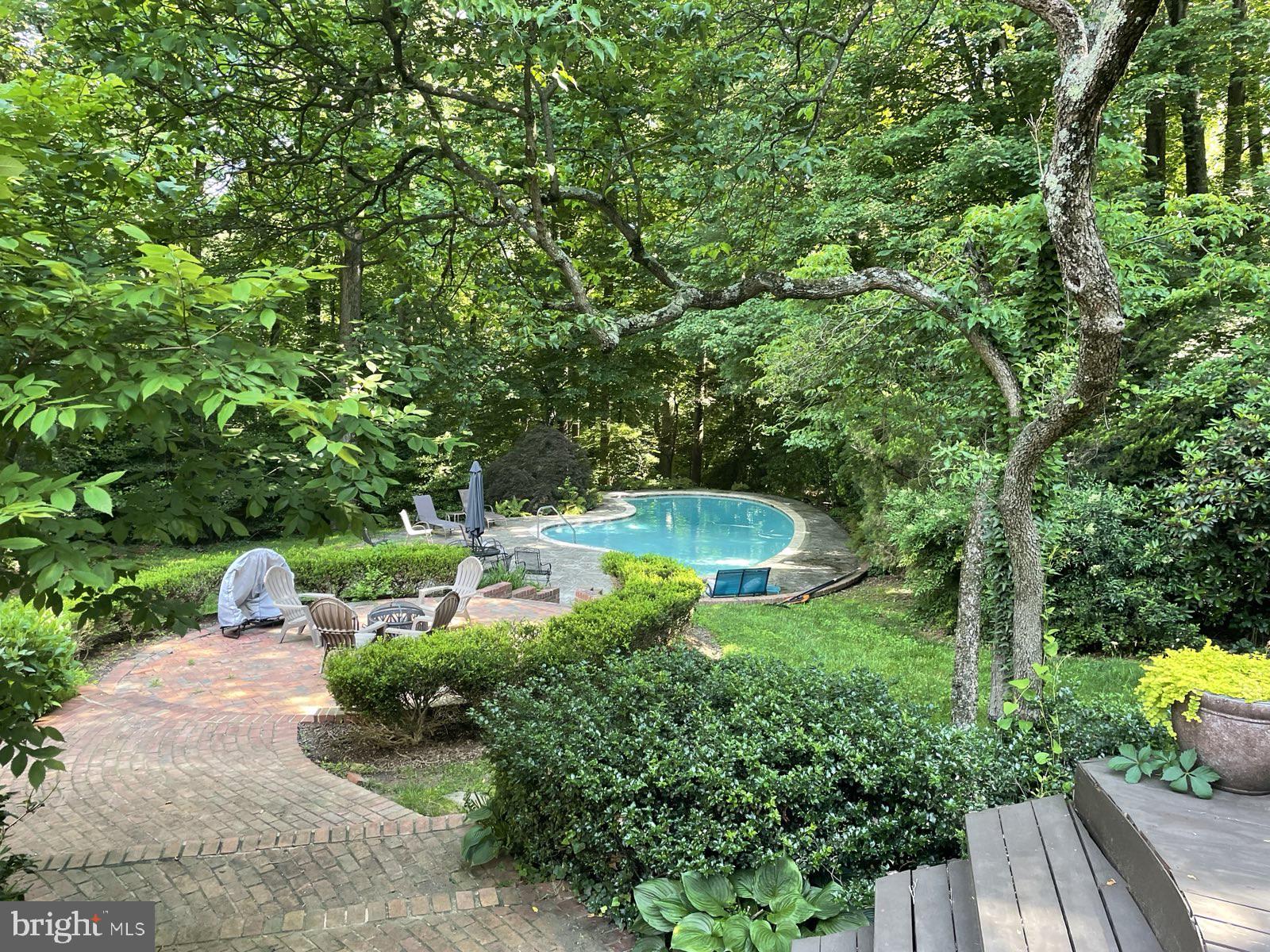 ***Offers if any are requested by Tuesday, 1 April, at 2pm.*** Welcome to 10504 Adel Road, a beautiful 4 Bed 3 Bath home, sitting on a gorgeous 1.15 acre lot, all  in a highly sought after location in Oakton, VA. As you drive up to the property you will notice that the perimeter of the property is surrounded by mature trees, offering privacy and serene views of nature.  All this complements stunning landscape work in the front and rear yards, featuring a  deck, leading down to a patio perfect for a fire pit, and a stunning pool. 

Inside you are greeted by a welcoming foyer with a coat closet, leading to a spacious dining room on the right and the living room on the left. The hardwood floors gleam in the all the natural light from the oversized windows and French doors leading out onto the deck.  As you continue on to the airy, eat-in kitchen you will notice the ample cabinet space, high end appliances, and the quaint, exposed brick wall with a cozy fireplace. The upper level features three bedrooms and two bathrooms, including a large primary room with a sitting area and two closets, one being a walk-in. The lower levels feature another bedroom and bathroom, a family room and rec room, and a gorgeous screened in porch with a vaulted ceiling, offering maximum flexibility on how to use these spaces. Hurry up and book a tour today, this opportunity to live in such a beautiful home with a breathtaking outdoor space will not last!

Septic is  7 years old. HVAC is  5 years old. Roof is   2 years old. Pool is heated.