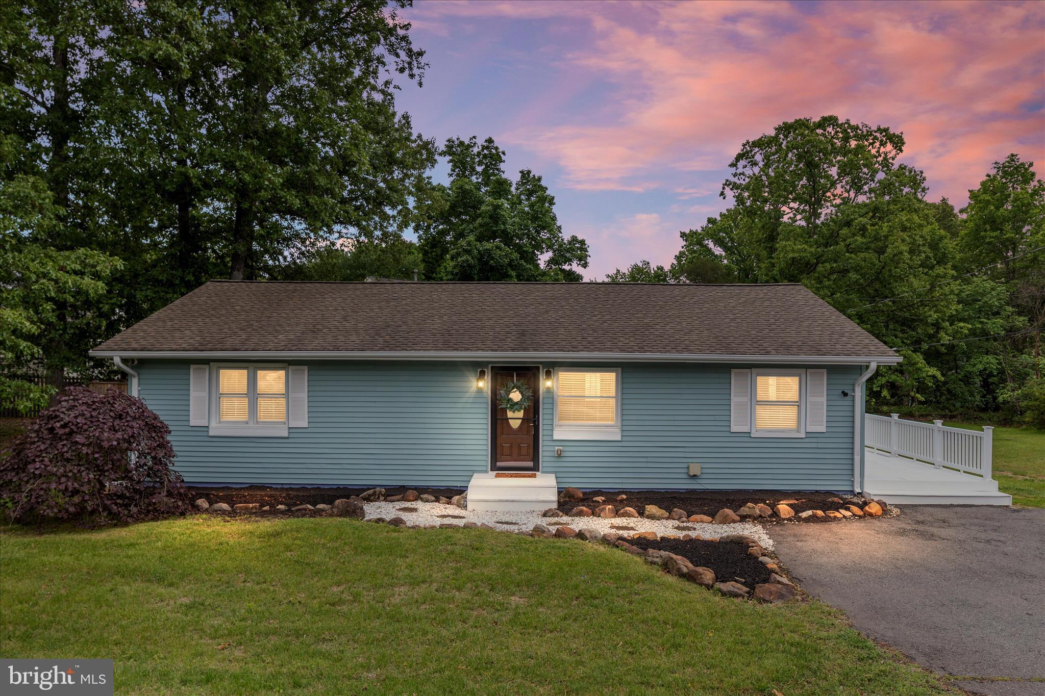 Located on a private 1-acre lot with no HOA, this updated and well-maintained ranch/rambler offers peaceful living in the heart of Gainesville. This charming one-level home features 3 cozy bedrooms and 2 full baths, along with numerous updates throughout. The partially wooded lot offers a great balance of privacy, natural beauty, and sunny space for gardening or outdoor enjoyment. Connected to public water and sewer, the property also includes an asphalt driveway with room for multiple vehicles. Brand new luxury vinyl and carpet have been installed. Recent improvements within the last 5 years include thermal windows, HVAC system, and a roof with an 8kW grid-connected solar array to help keep utility costs low. The kitchen features updated appliances, while the guest bath combines vintage charm with modern finishes including a cast-iron tub, subway tile accents, and quartz vanity.  Easy access to Routes 29, 28, I-66, and the Broad Run VRE station.  Rarely can you find acreage, privacy, and no HOA restrictions this close to major commuter routes, shopping, restaurants, top rated schools and entertainment.